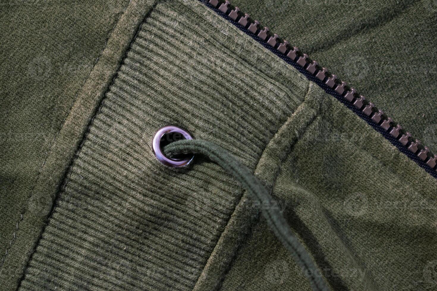 Silver ring on Green army fabric background texture. photo