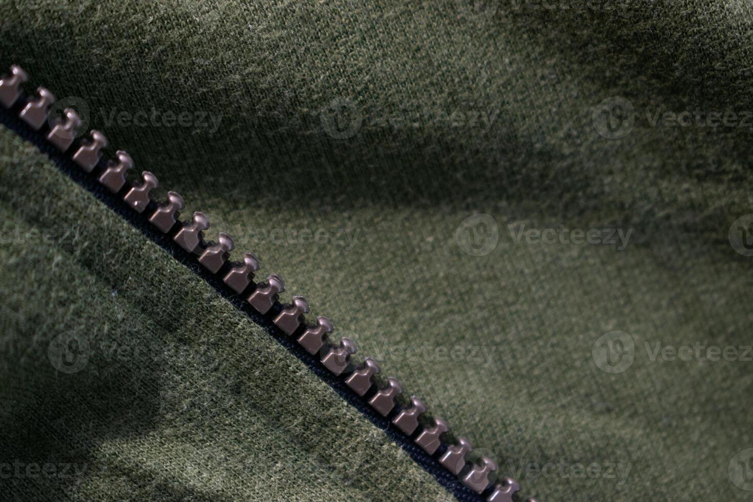 Zipper on background texture Green army jacket fabric. photo