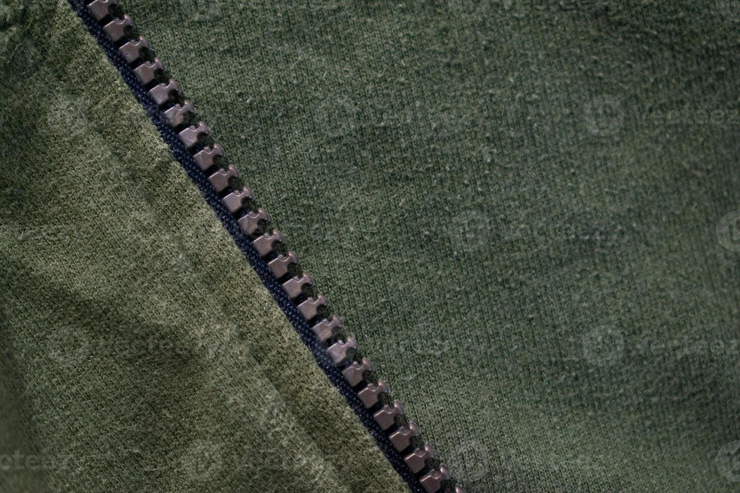 Zipper on Green army jacket fabric texture background. photo