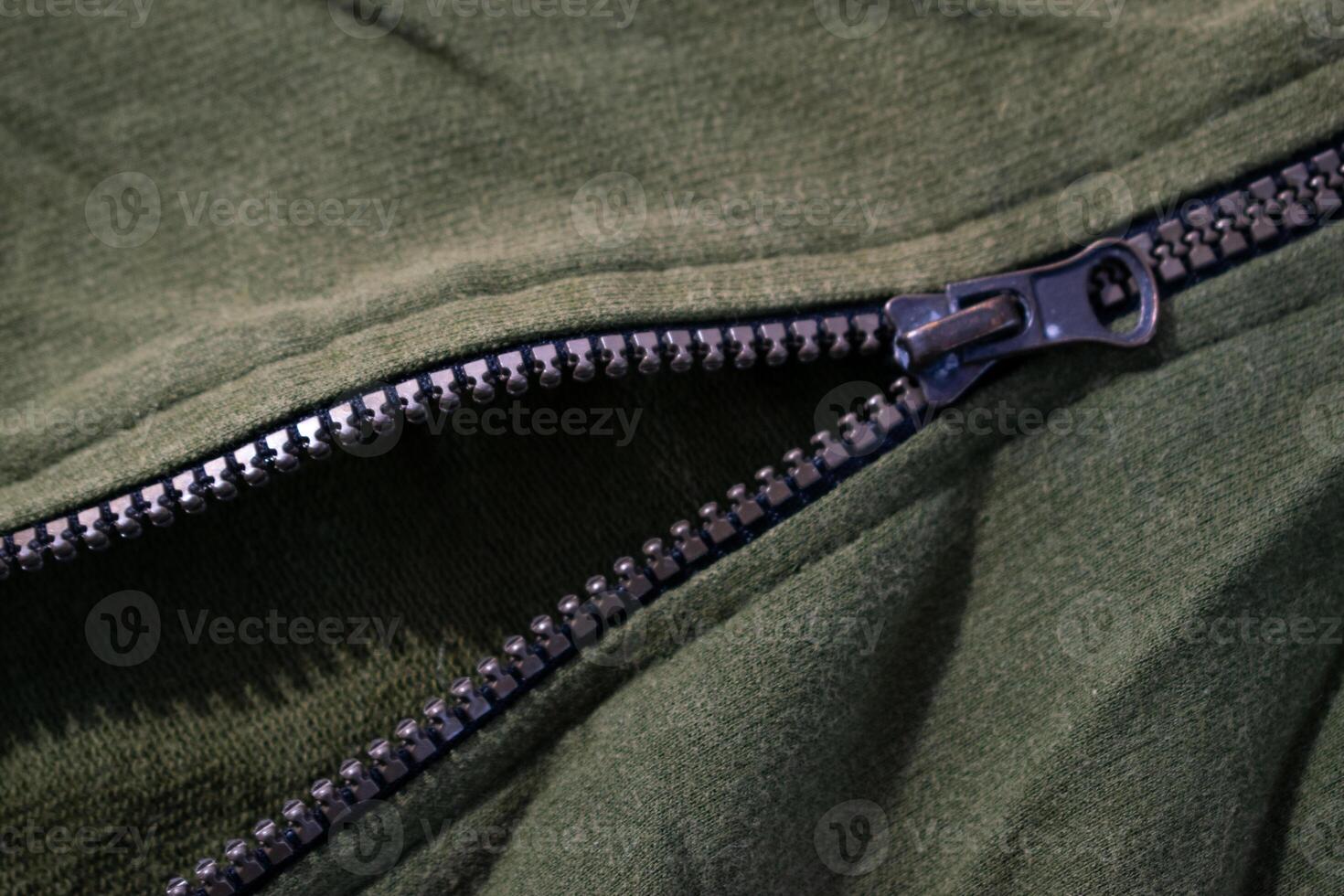 Zipper on Green army jacket texture fabric background. photo