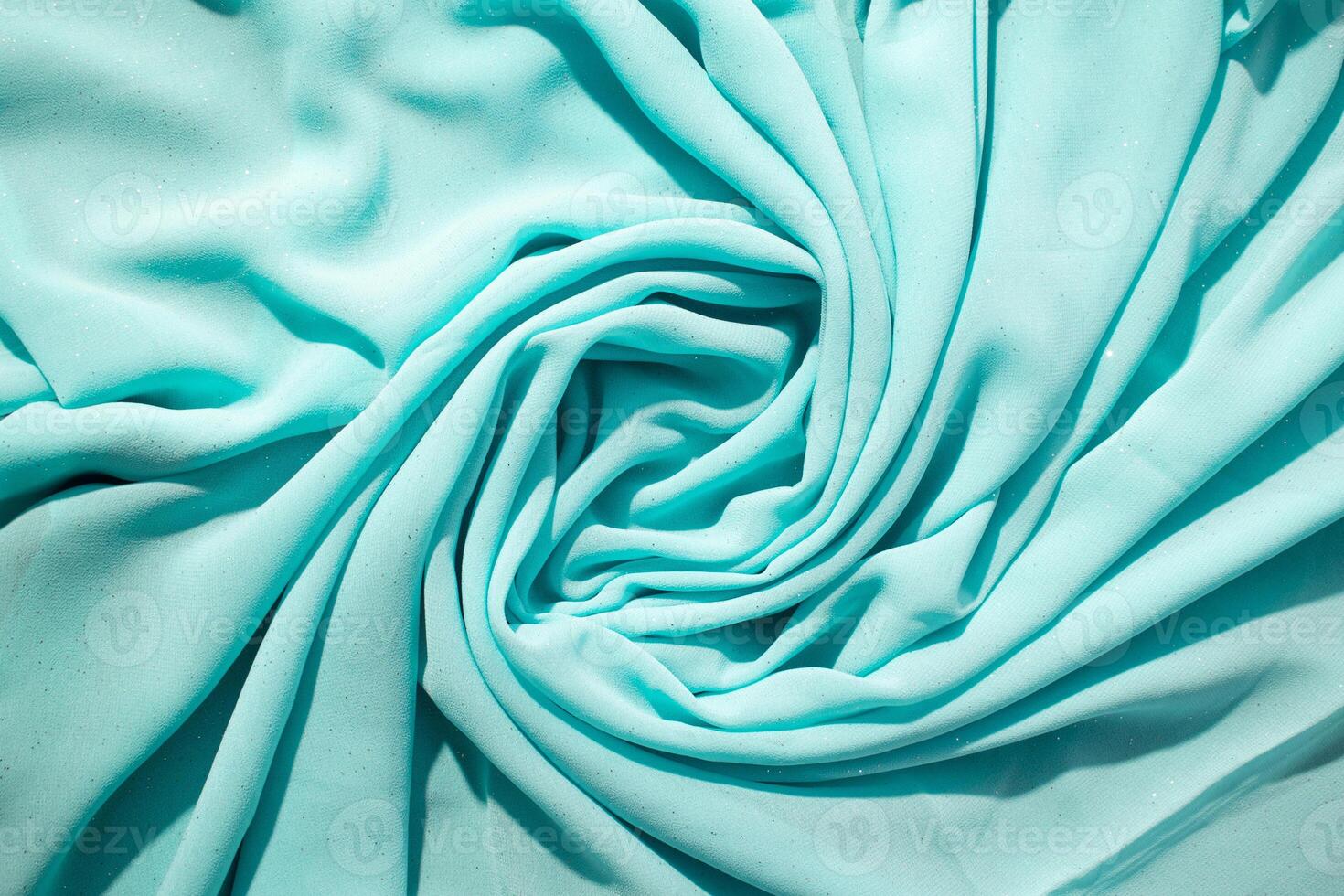 Spiral Twisted Turquoise wavy crumpled fabric with little sparkling dust photo