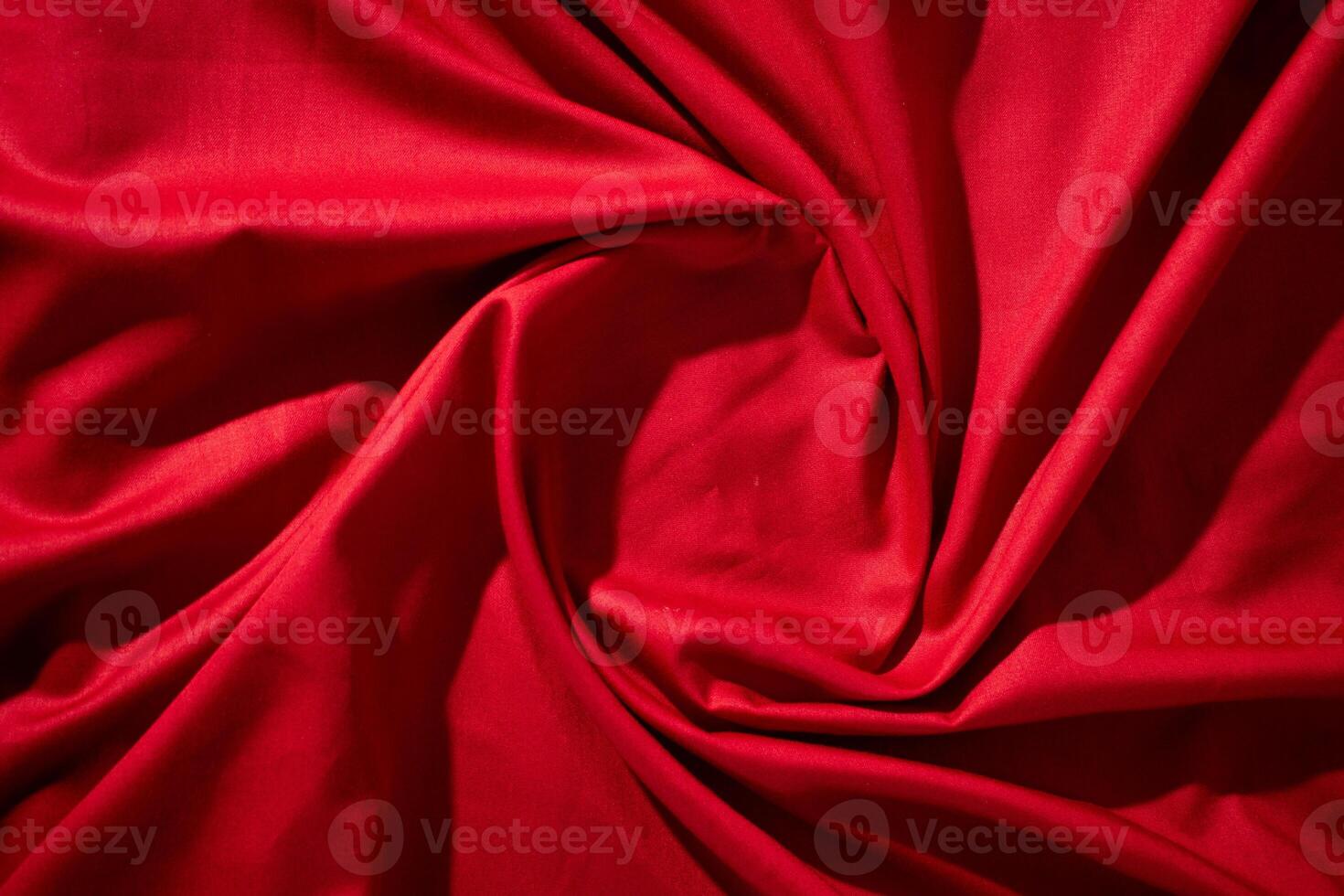 Red fabric wavy spiral crumpled texture with copy space. photo