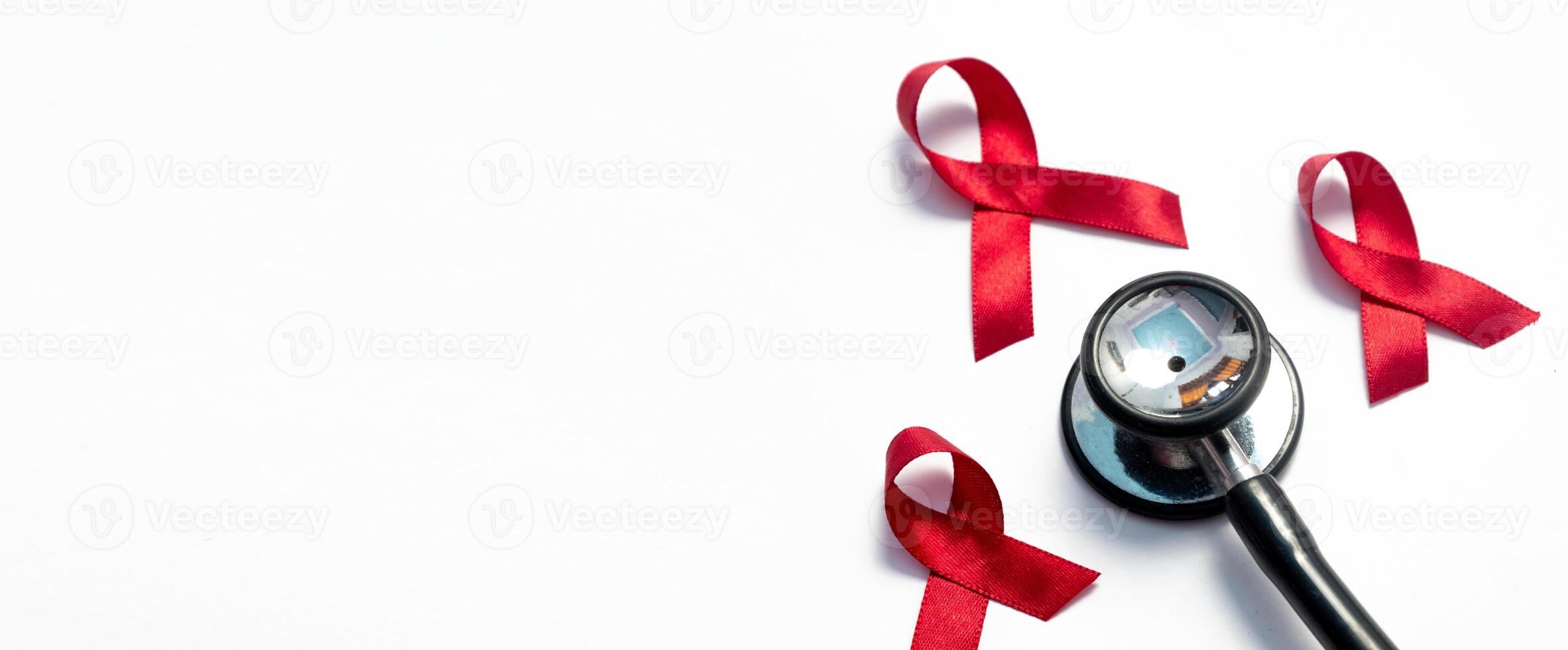 Red ribbon and stethoscope, HIV awareness, AIDS day, world cancer day isolated white background. photo