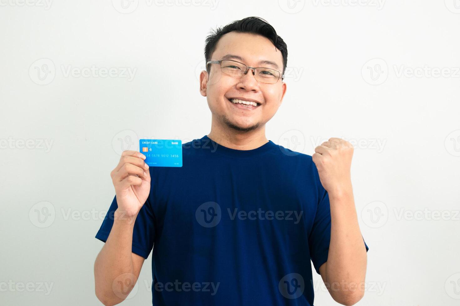 Happy asian man Celebrating pose with hold credit card. Banking, Financial concept and fist up gesture. photo