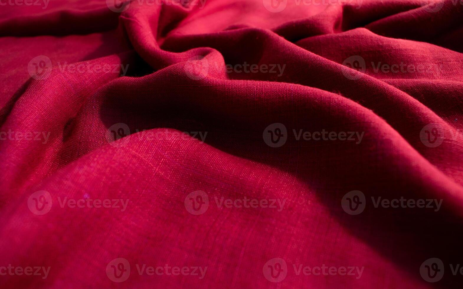 Close up folded Red fabric wavy crumpled background texture. photo