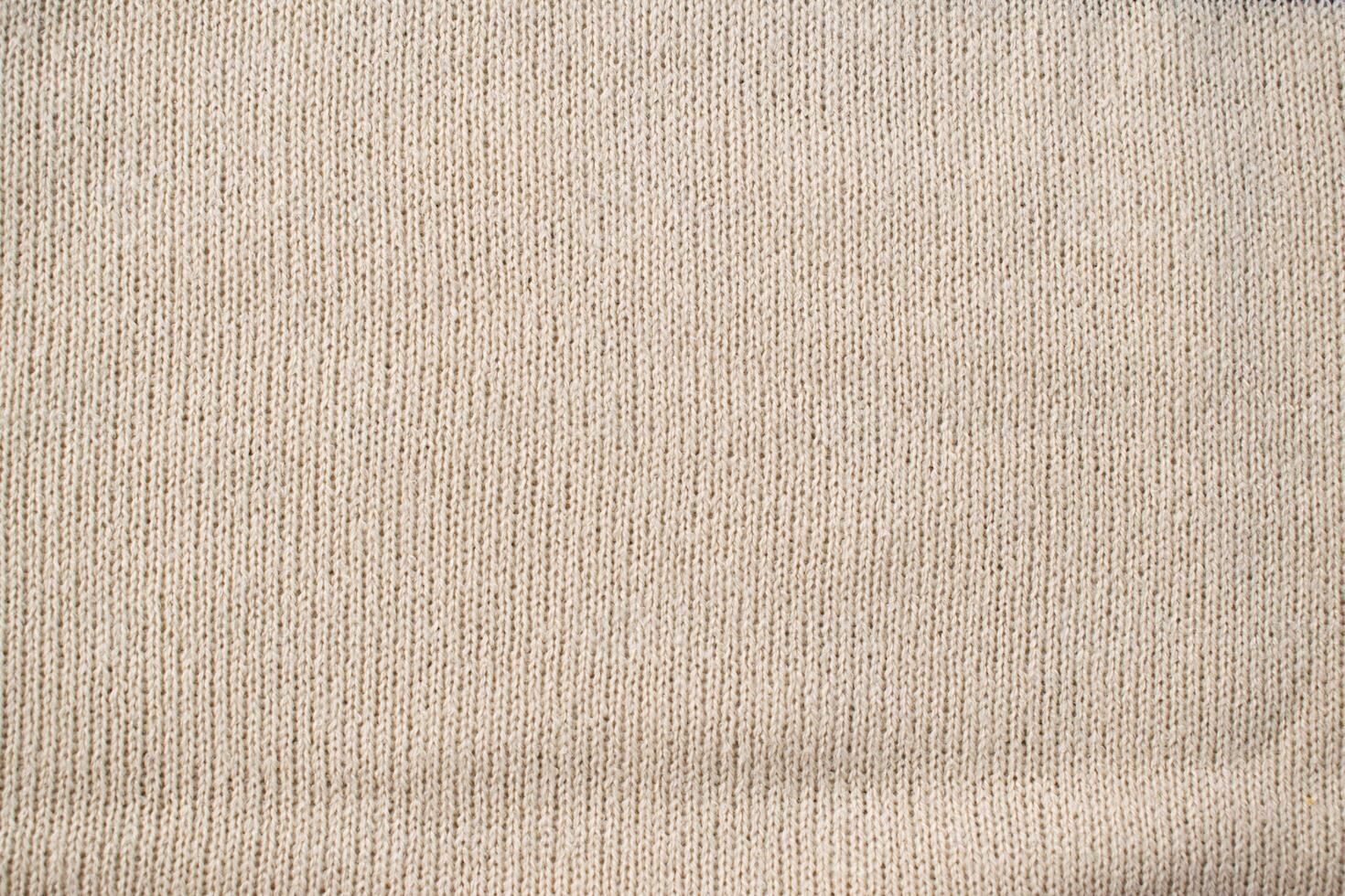 Detailed white cream or vanilla knitted fabric background texture. photo