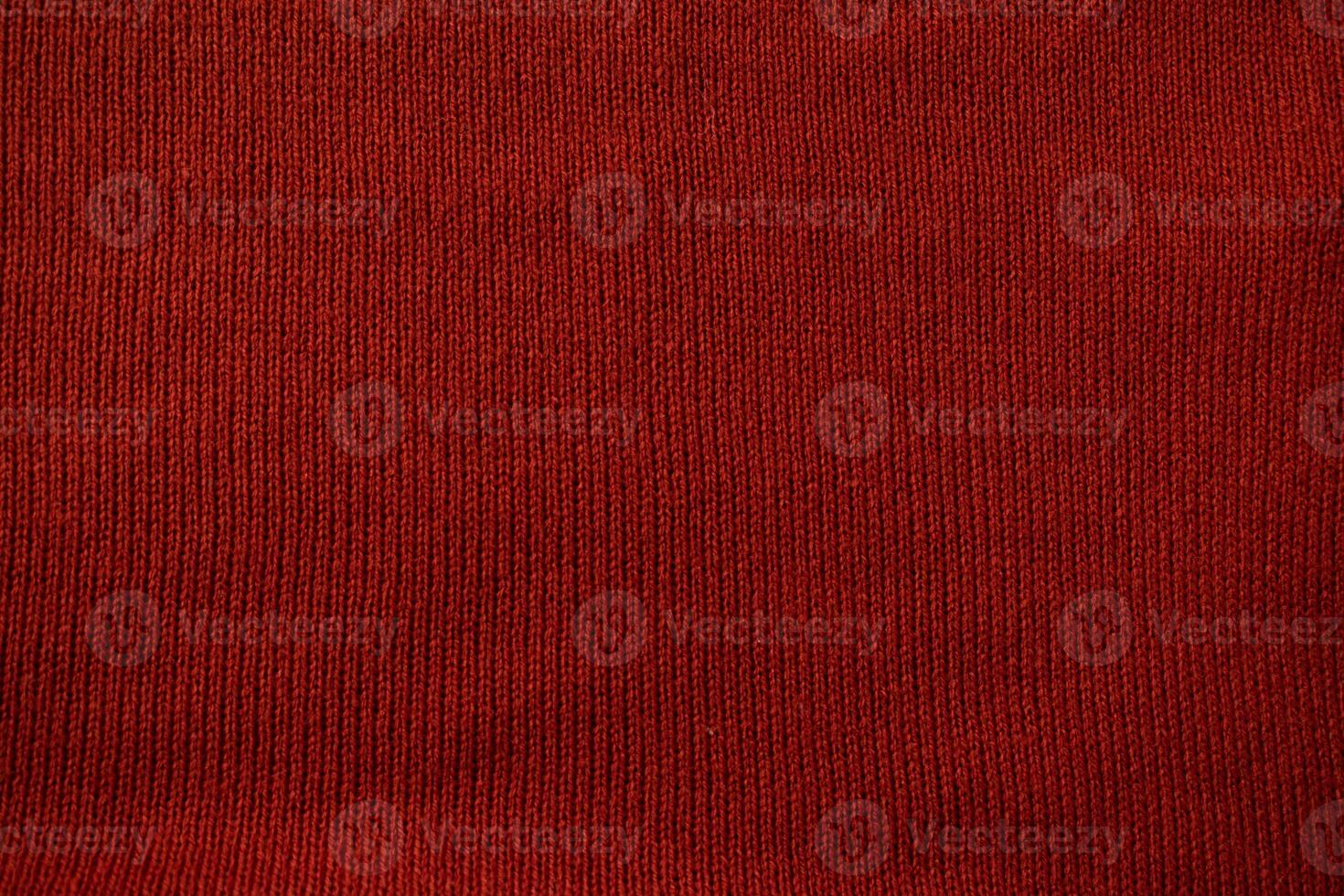 Detailed red knitted fabric background texture. photo