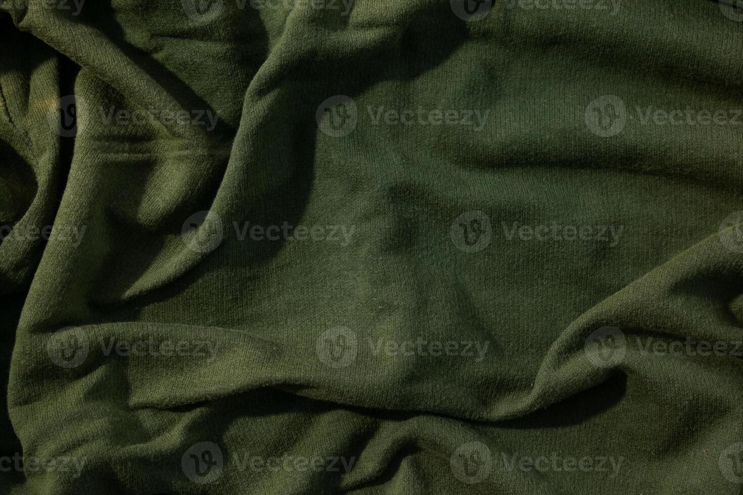 Green army fabric wavy crumpled anstract background texture. photo