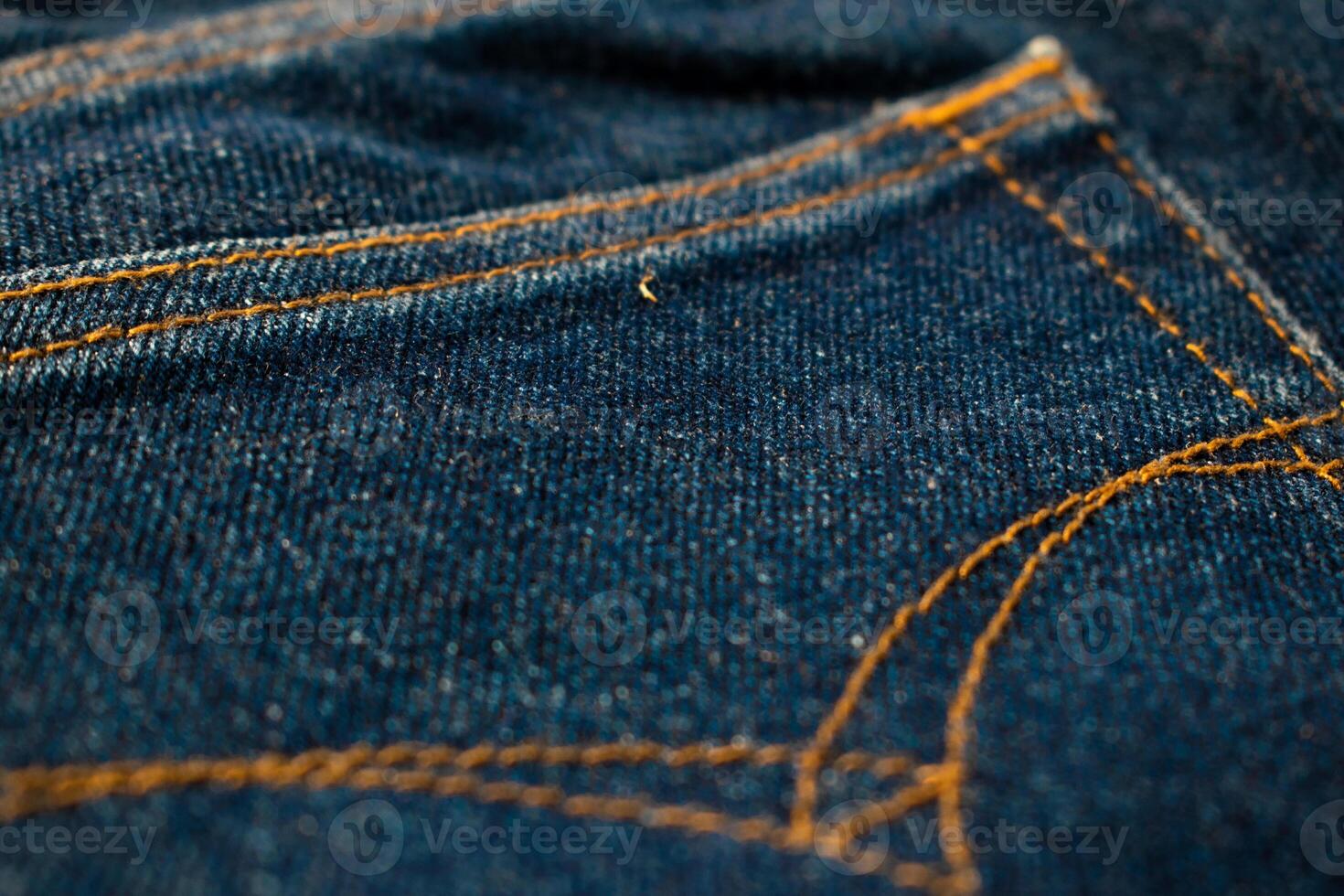 Close up Back pocket of navy blue jeans fabric texture. photo