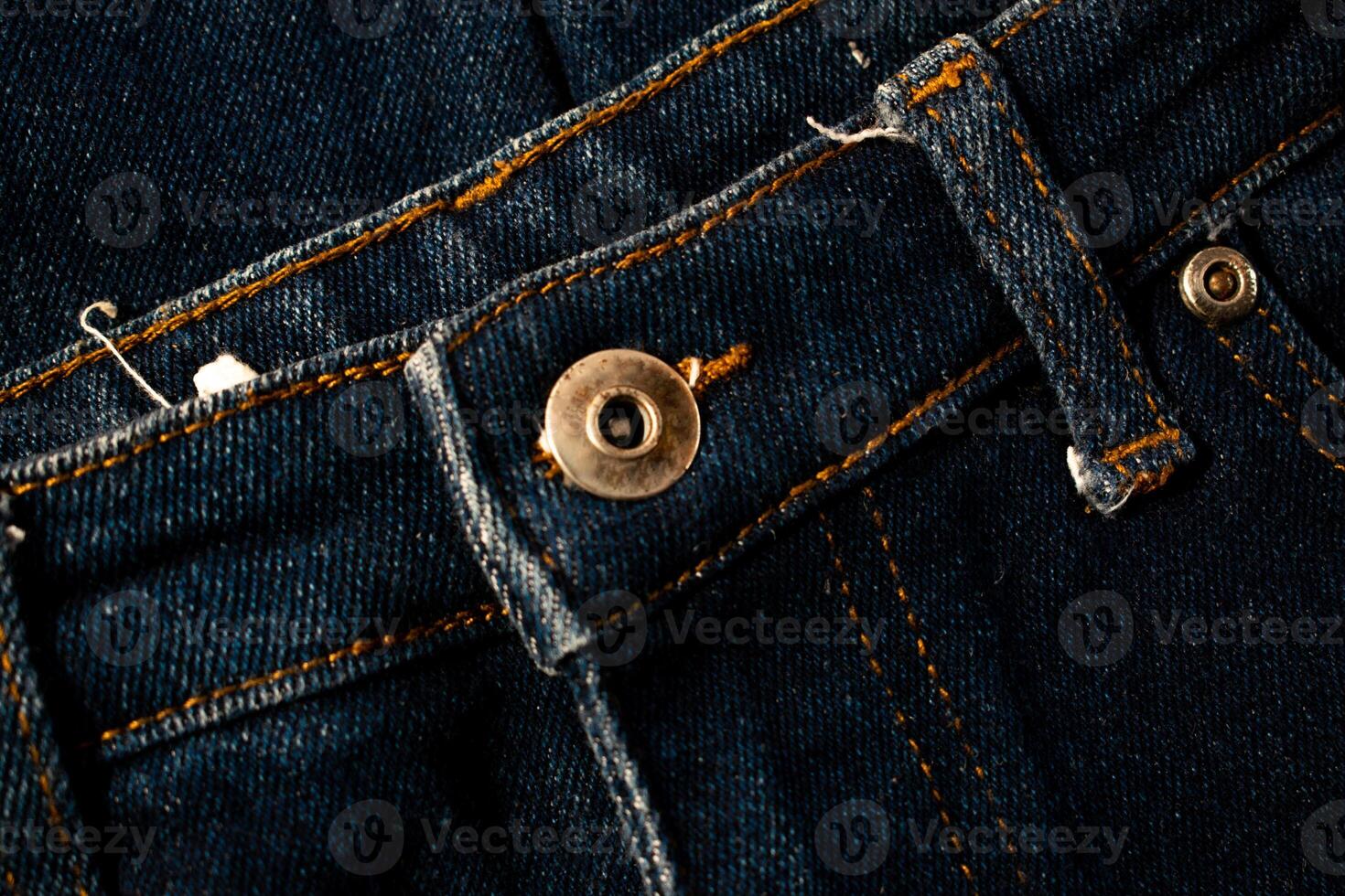 Close up gold and shiny button navy blue jeans fabric, product mockup background texture. photo