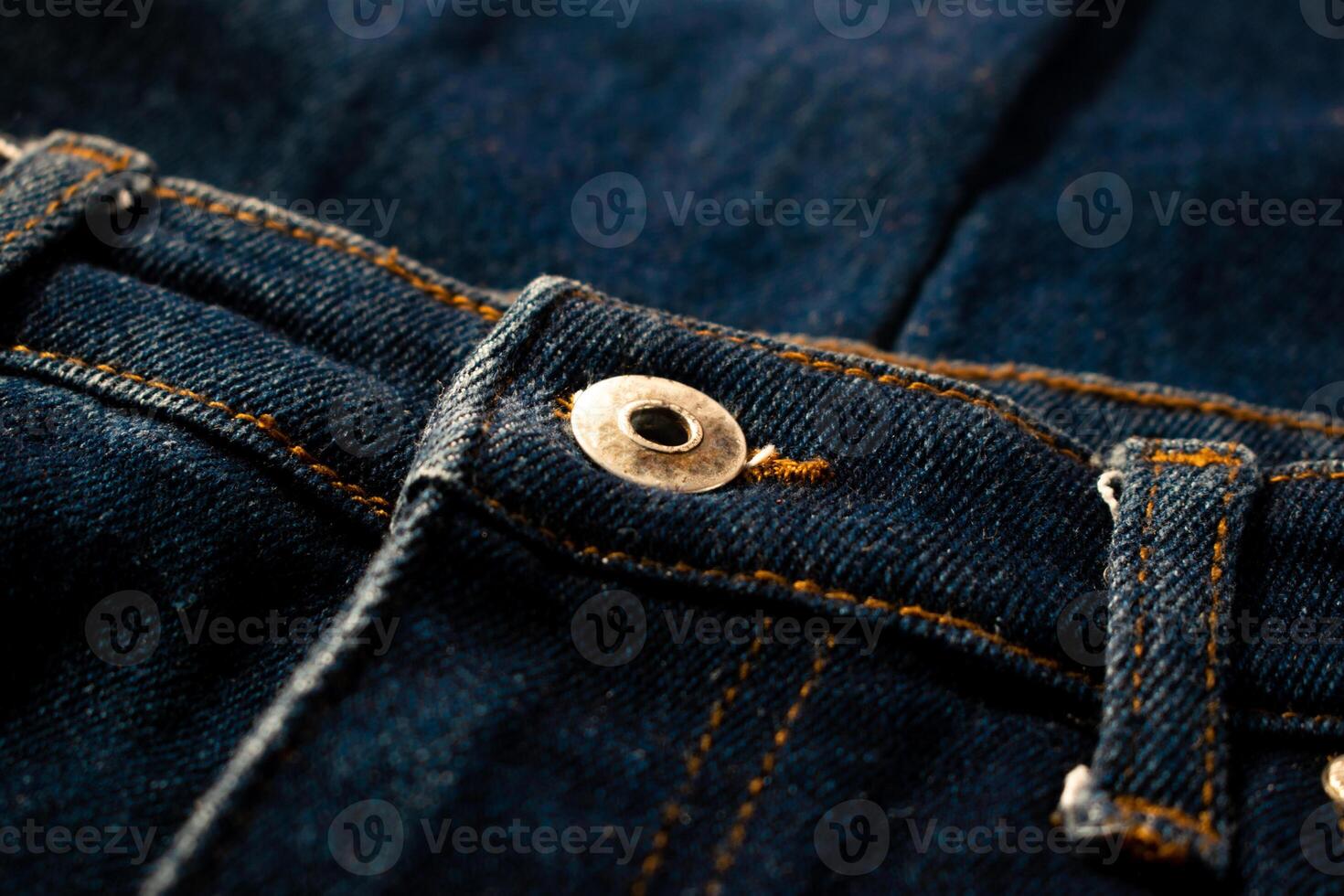 Close up gold and shiny button navy blue jeans fabric, mockup background texture. photo