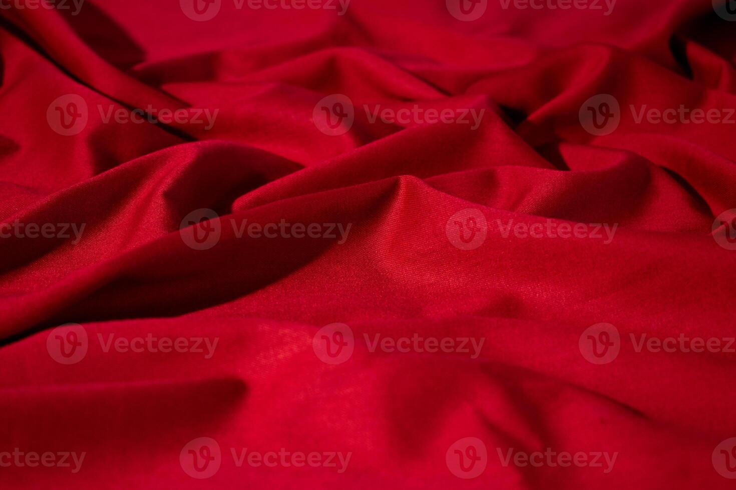 Crumpled wavy Red silky fabric texture. shiny and glossy. photo
