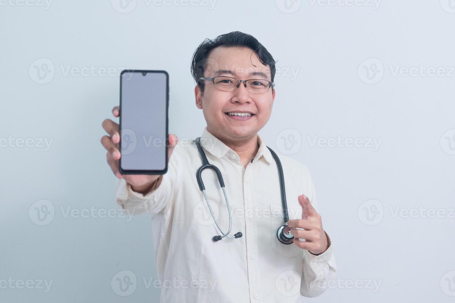 happy Asian man doctor, male nurse Pointing and showing phone isolated white photo
