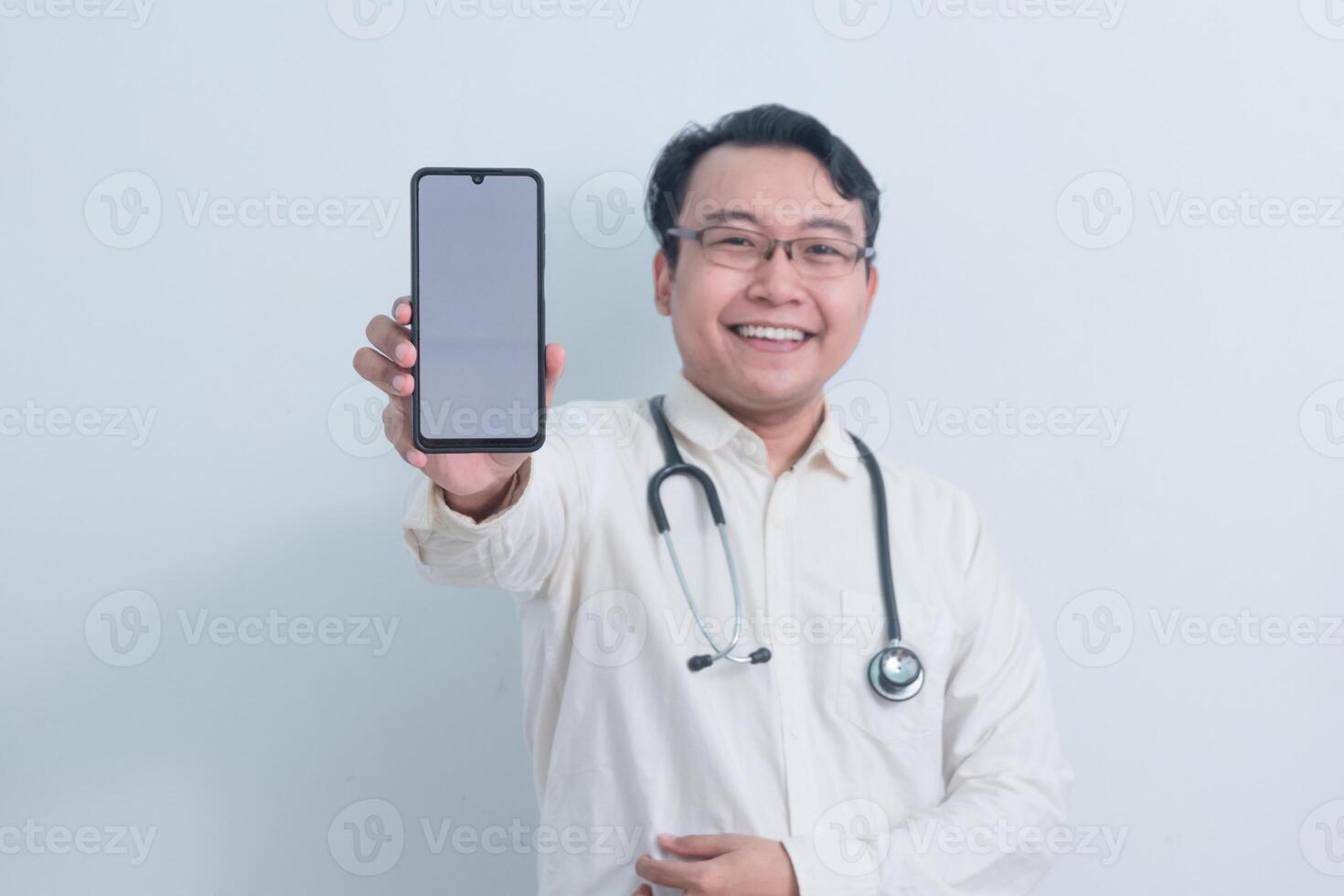 happy Asian man doctor, male nurse Pointing and showing phone at the camera isolated white background. photo