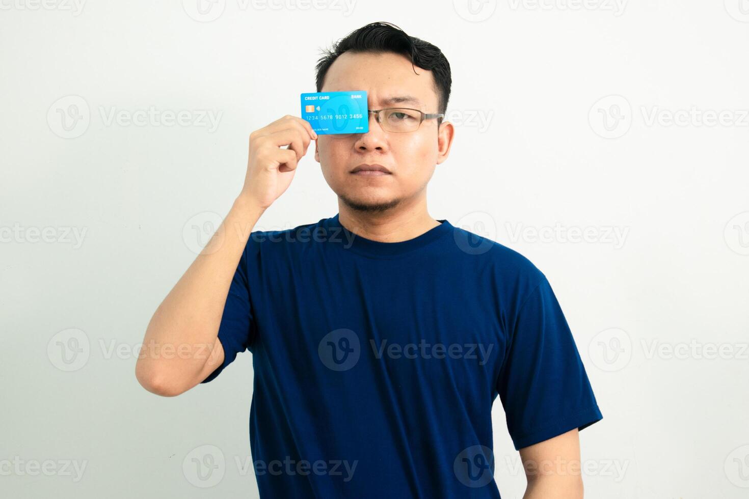 Joyful asian man hold credit card over head. Banking, Financial isolated background, blue color concept. photo