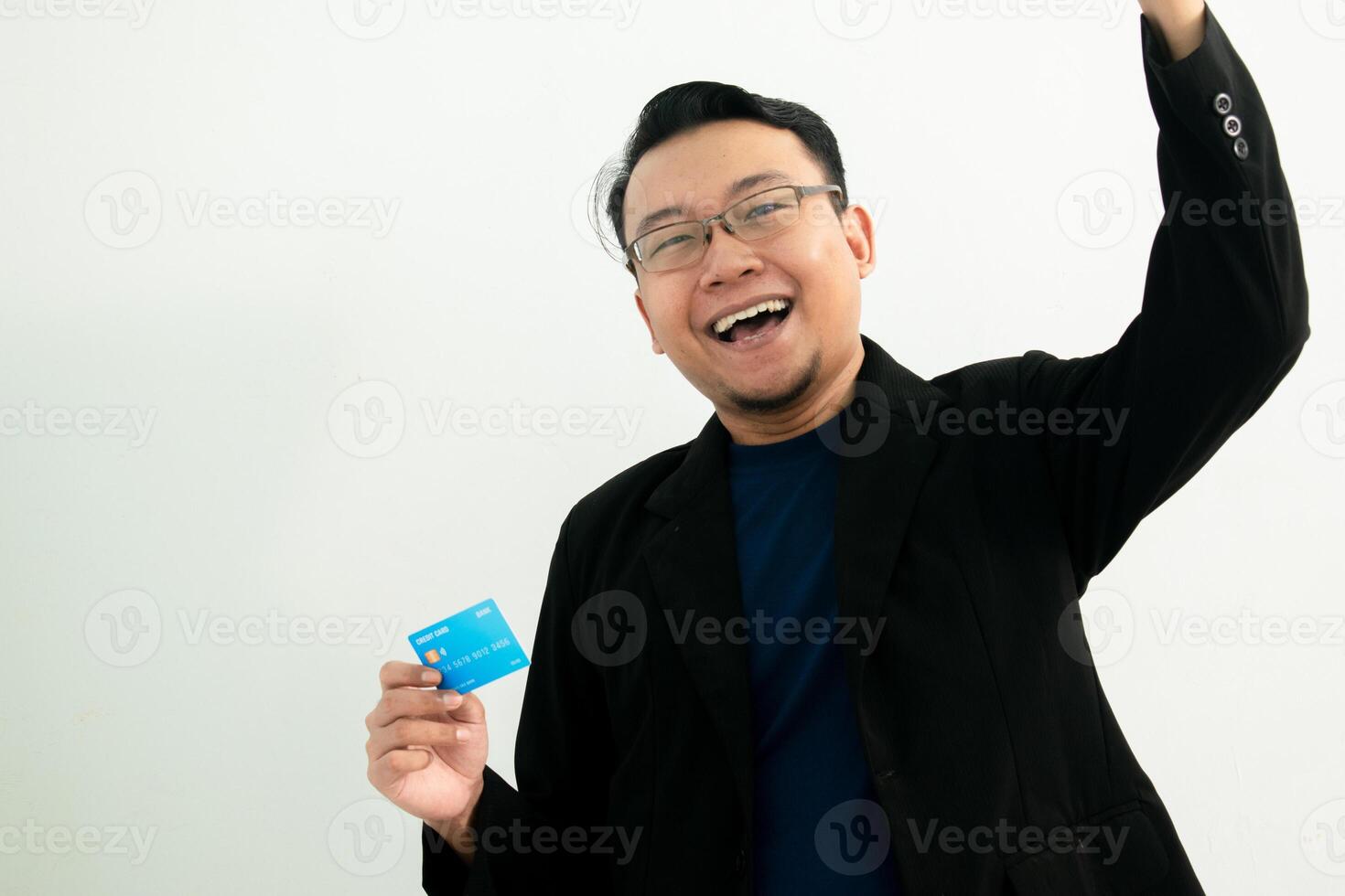 Smiling asian businessman Celebrating pose with hold credit card. Banking, Financial concept and fist up gesture. photo