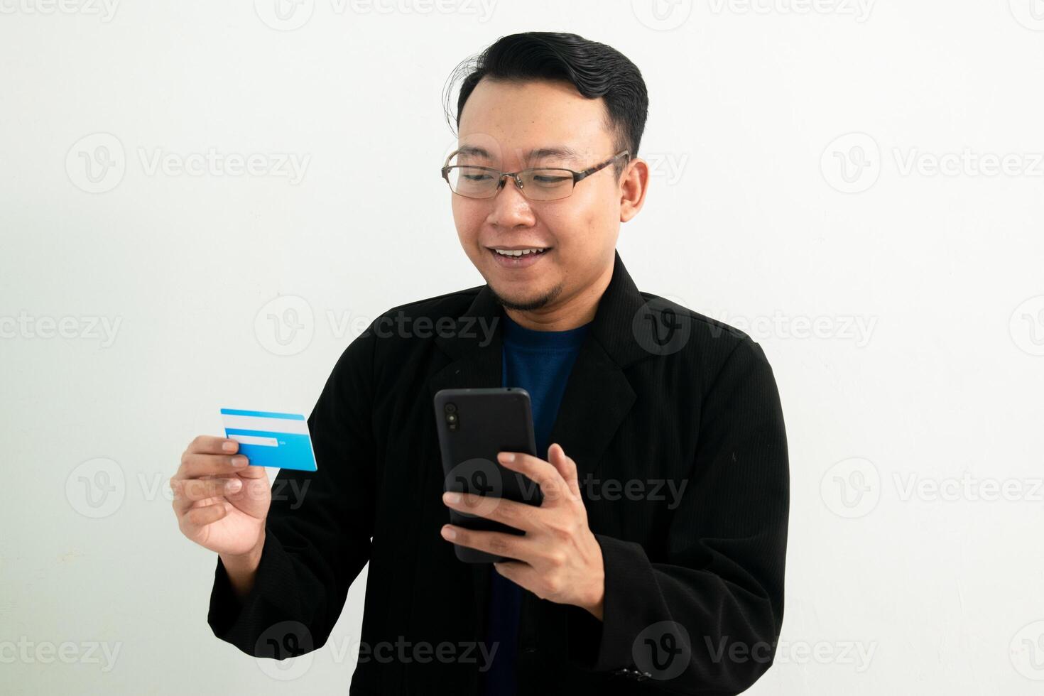 Smiling asian businessman hold credit card and phone. Banking, Financial and technology isolated concept. photo