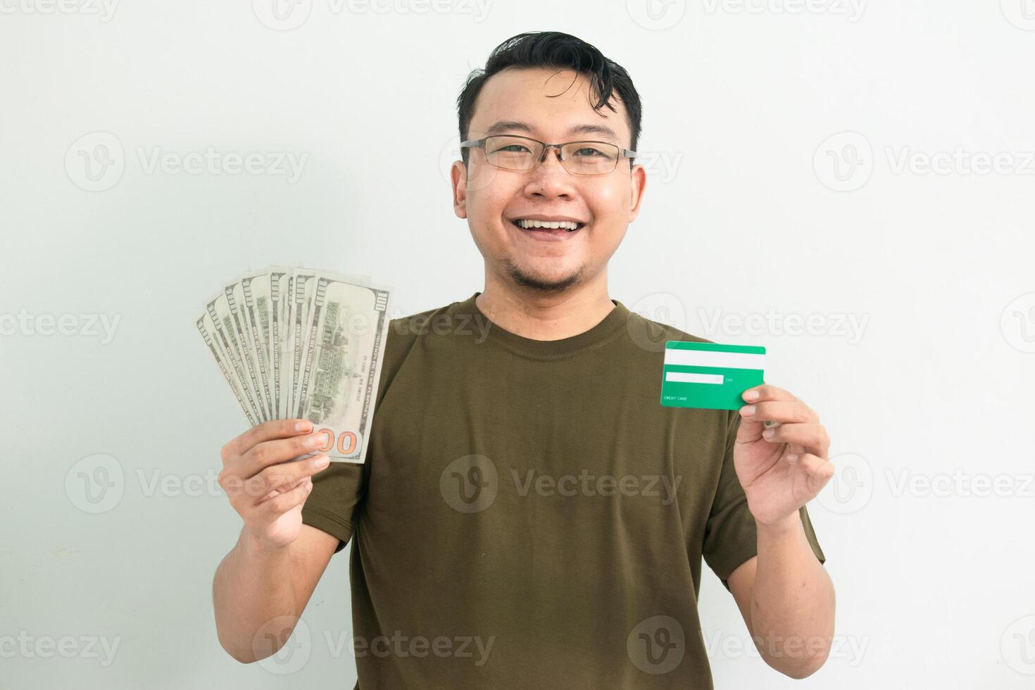 Joyful asian man hold credit card and money. Banking, Financial isolated background, green color concept. photo