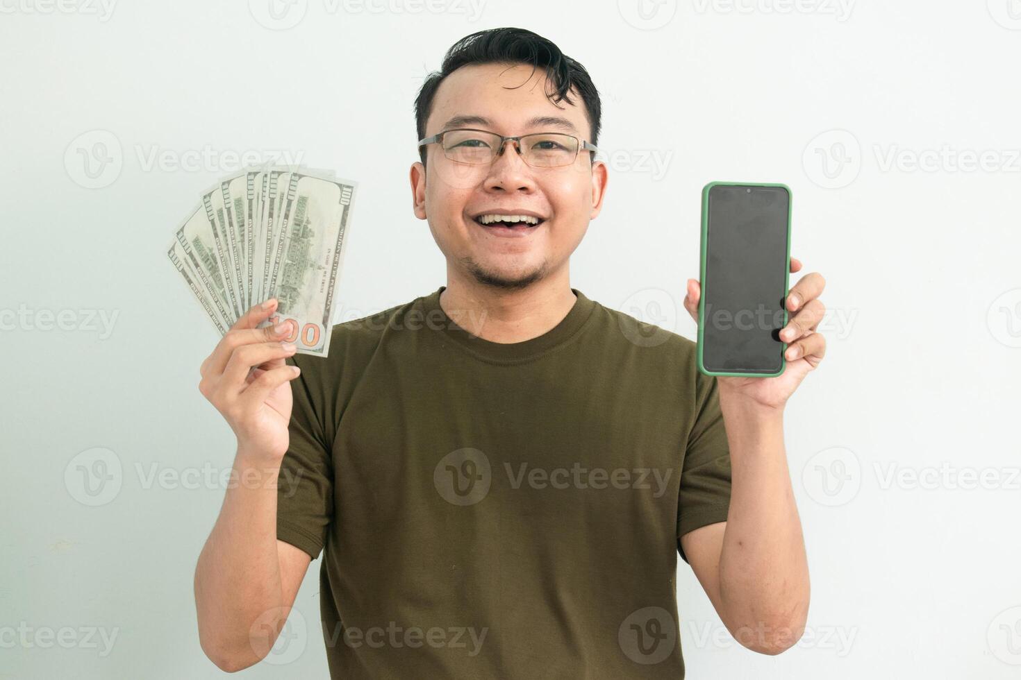 Happy asian man hold Money and showing phone screen. Banking, Financial and technology isolated background, green color concept. photo