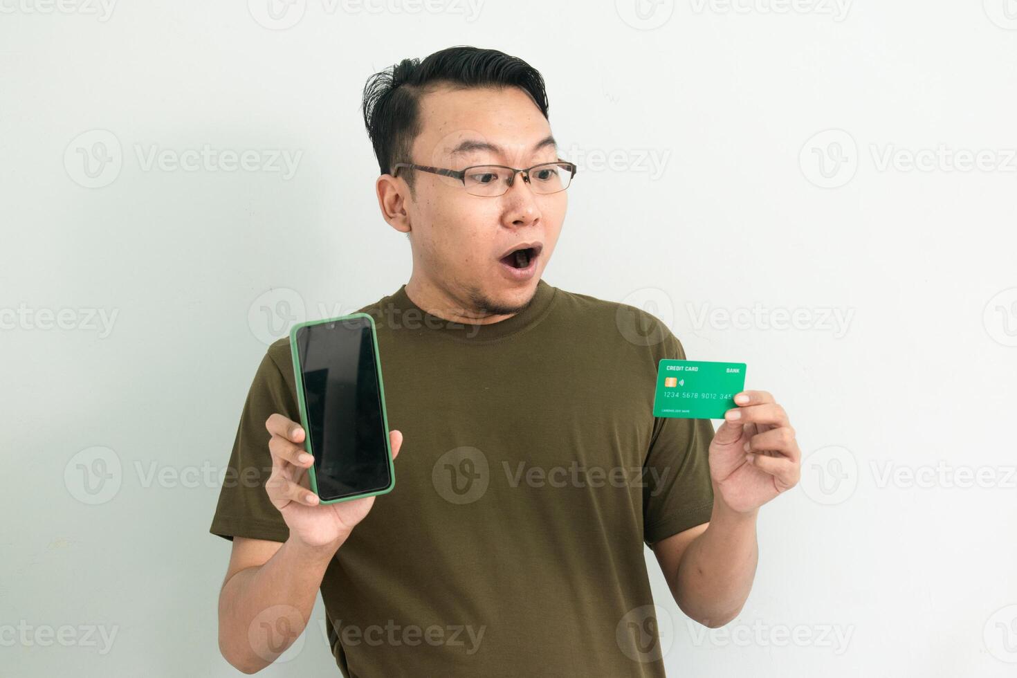 Amaze Asian man doing transaction with credit card and phone. Banking, Financial and technology isolated concept. photo