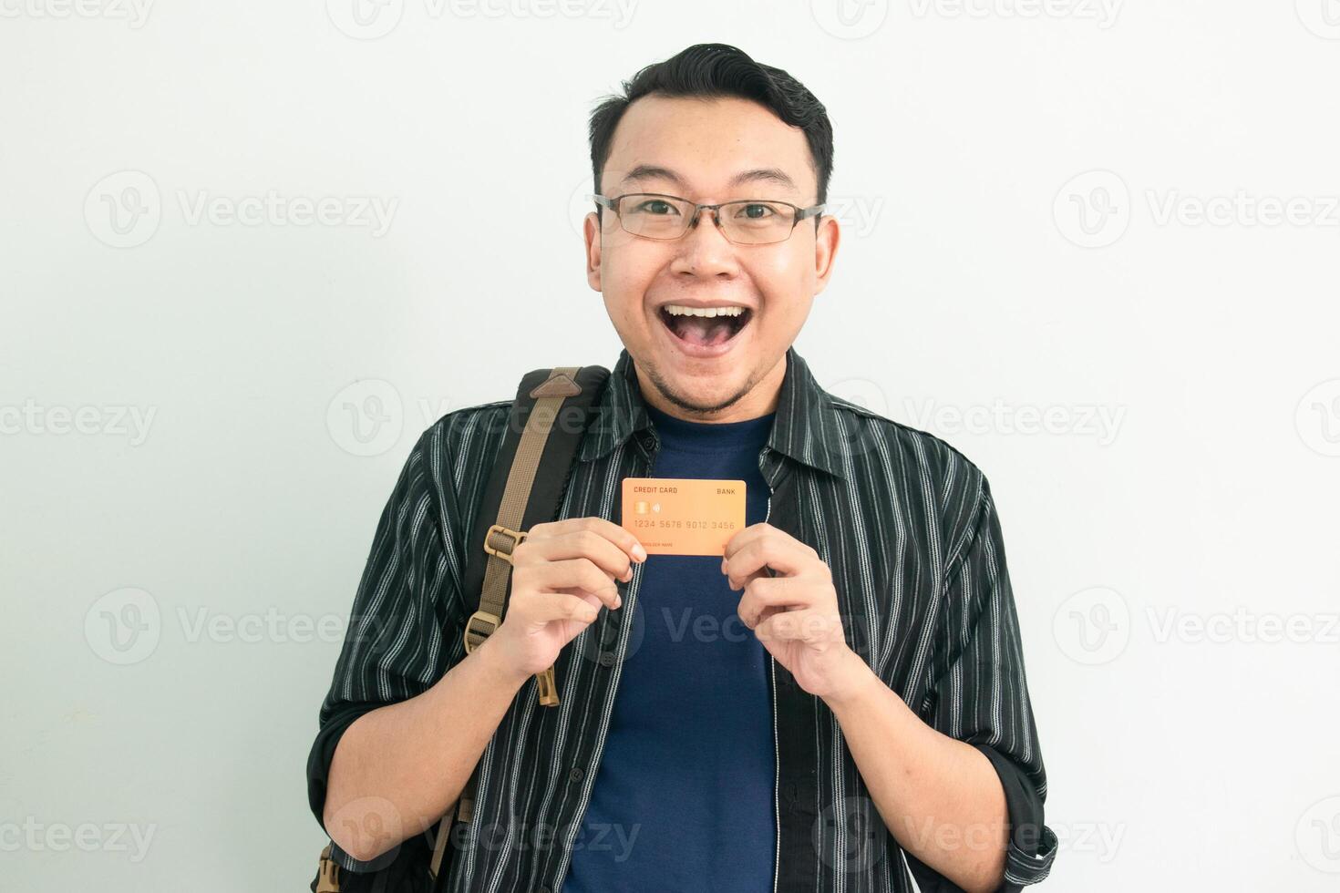 Shocked Asian Student hold credit card. School, Banking, Financial isolated white background photo