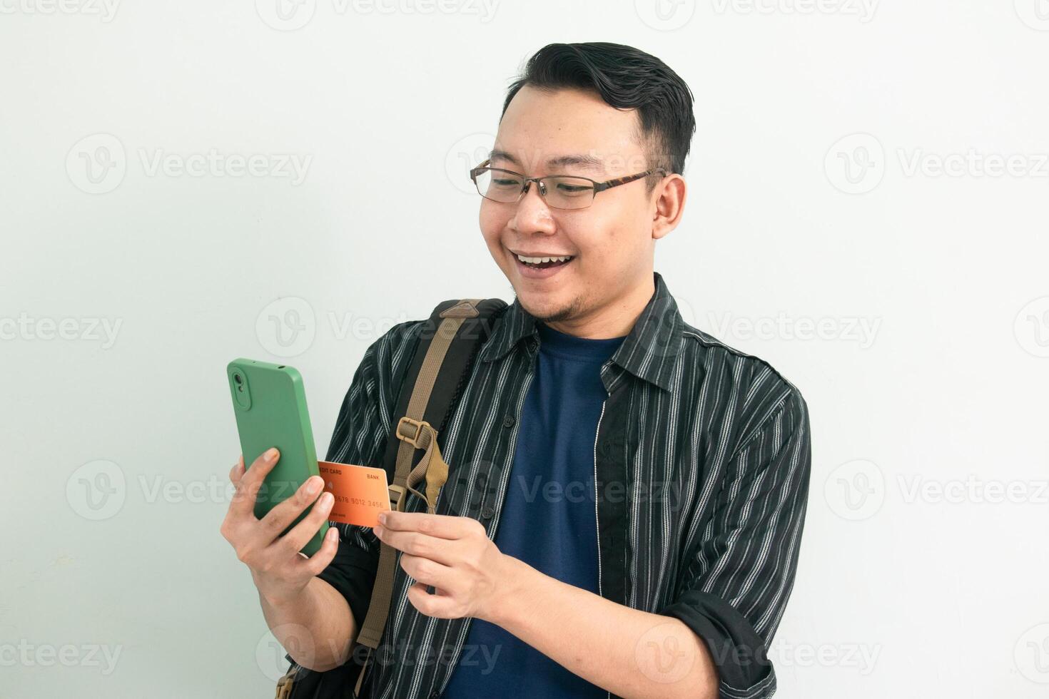 Happy asian student doing online transaction with phone and credit card. Banking, Financial isolated concept. photo