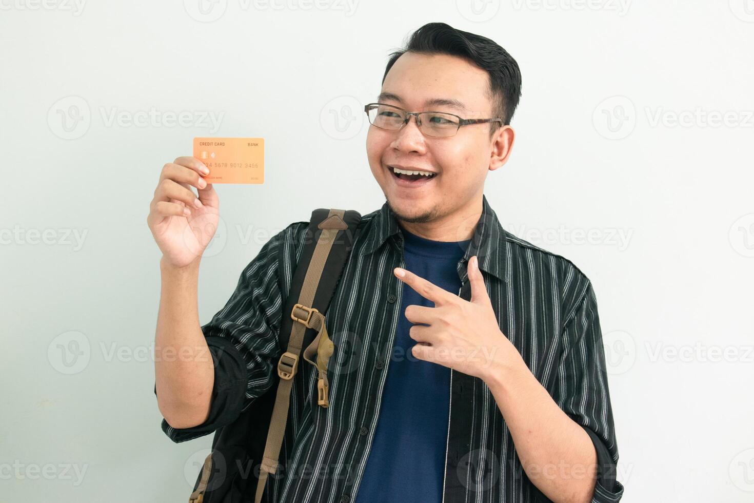 Happy asian student hold and pointing credit card gesture. Banking, Financial isolated concept. photo