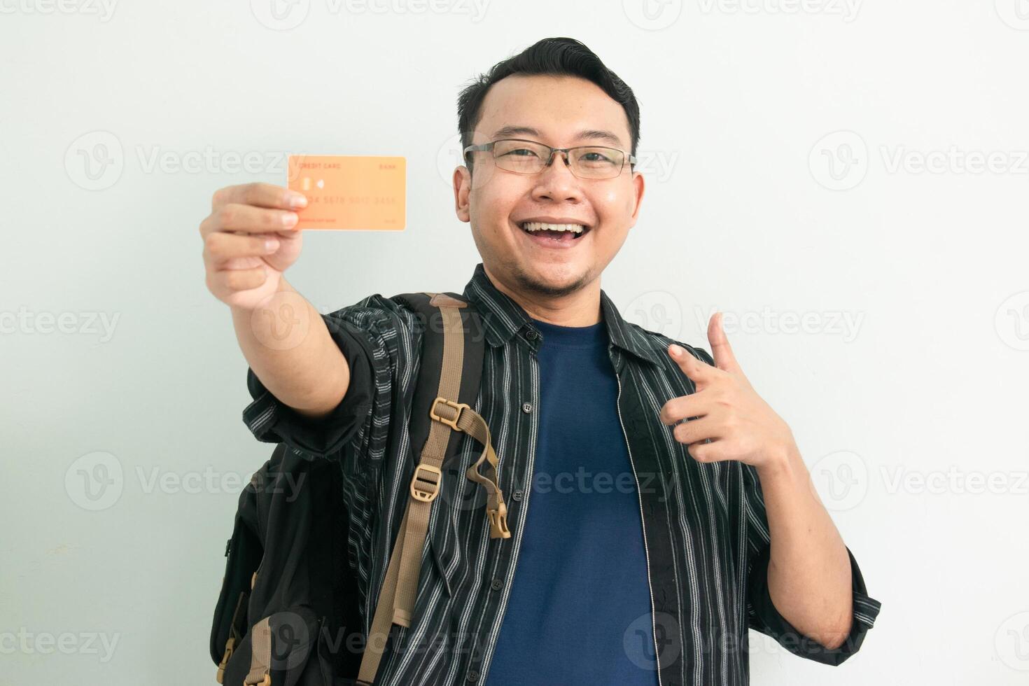 Joyful asian student hold and pointing credit card gesture. Banking, Financial isolated concept. photo