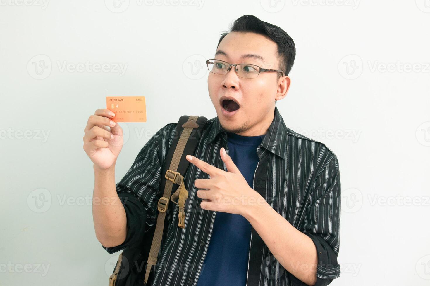 Surprised asian student hold and pointing credit card gesture. Banking, Financial isolated white background photo