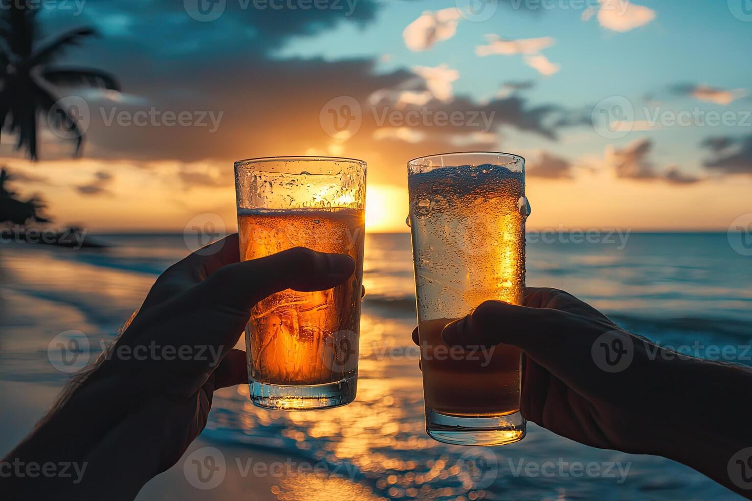 Two hands holding two glasses of beer on the beach at sunset photo