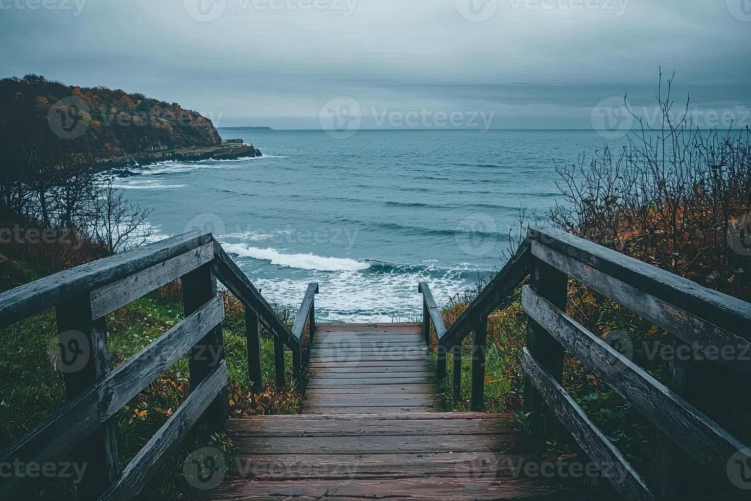 Wooden stairs leading to the sea on a cloudy autumn day photo