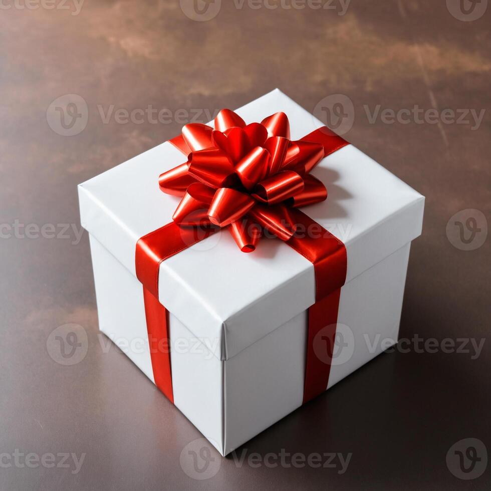 A white box tied with a red ribbon on a dark background. bow made of red ribbon. photo