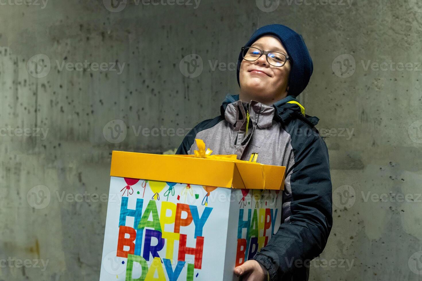 Happy boy holding a big birthday gift box photo