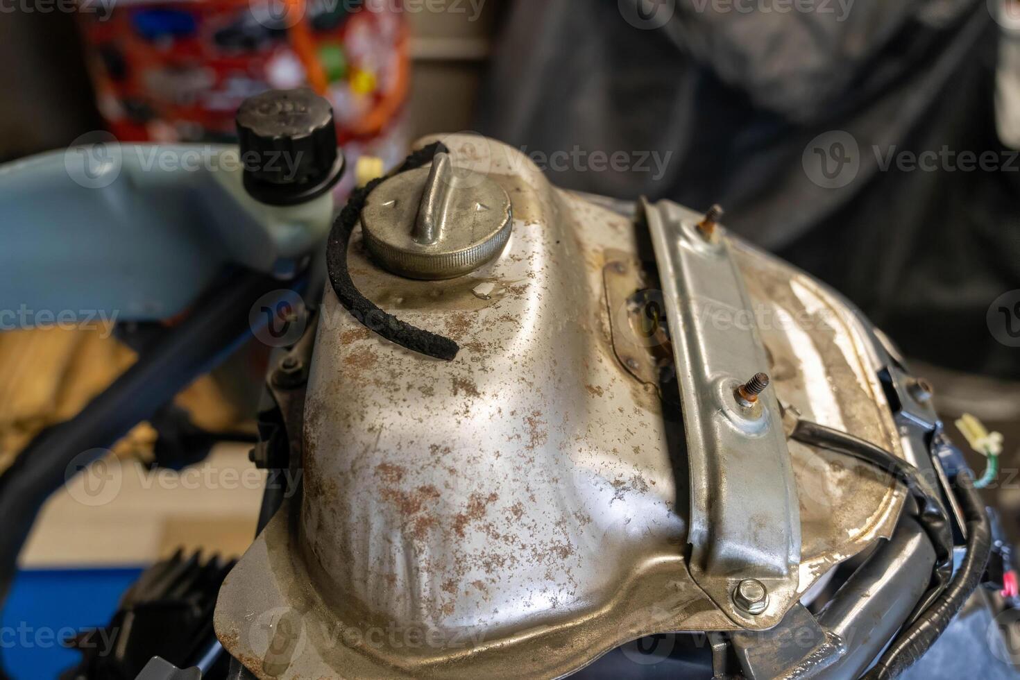 Rusty fuel tank awaiting repair in garage workshop photo