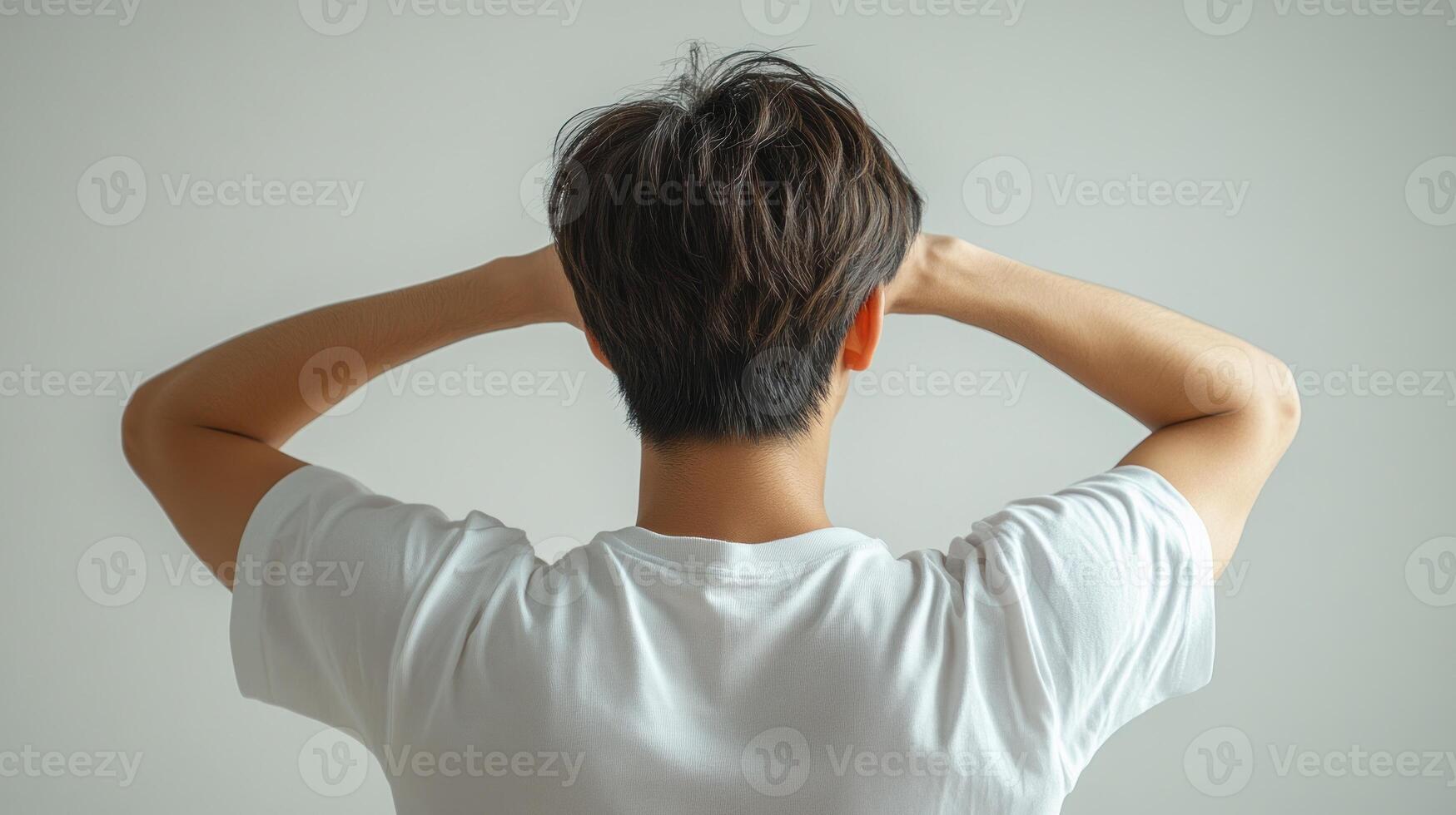 A thoughtful moment captured as a figure reflects silently against a minimalist backdrop photo