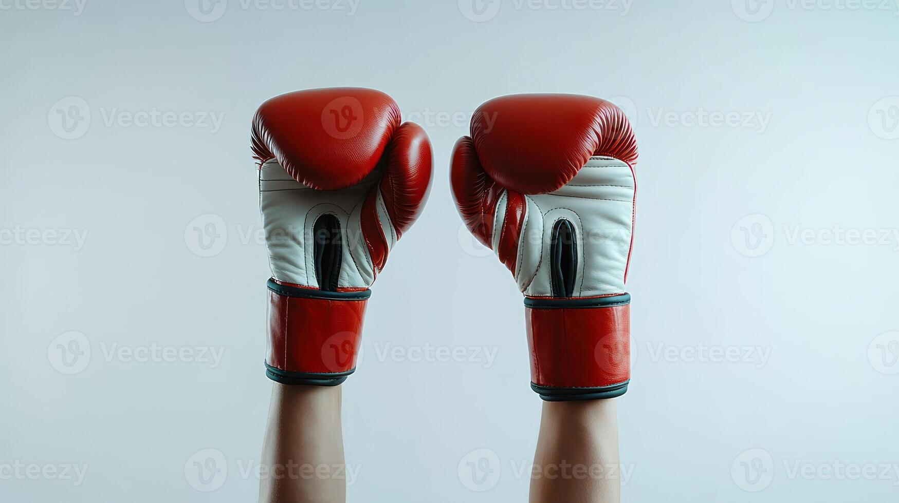 Two boxing gloves triumphantly lifted in the air, celebrating victory after a match photo
