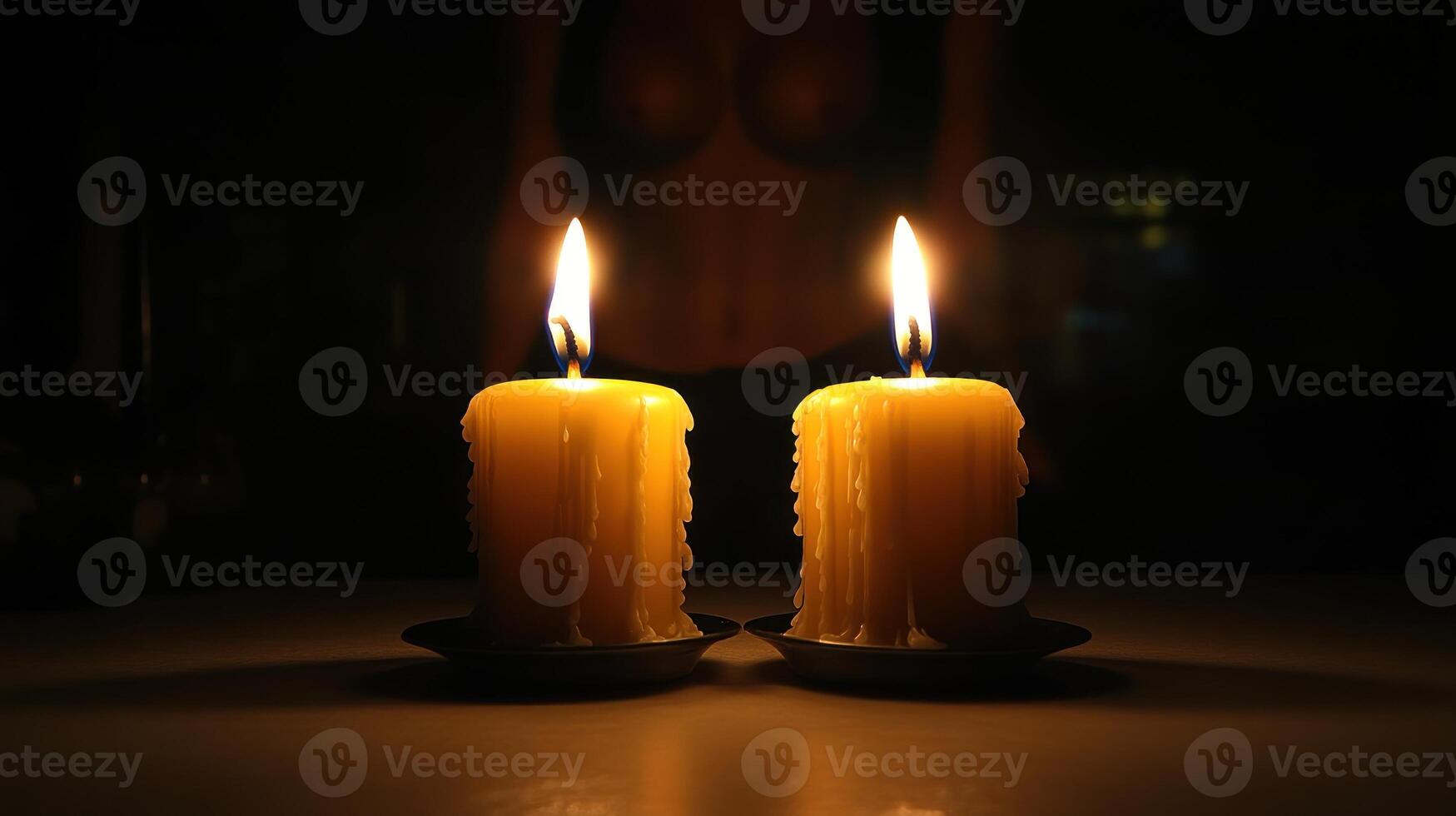 Soft candlelight flickers, creating a tranquil atmosphere in the dim room photo