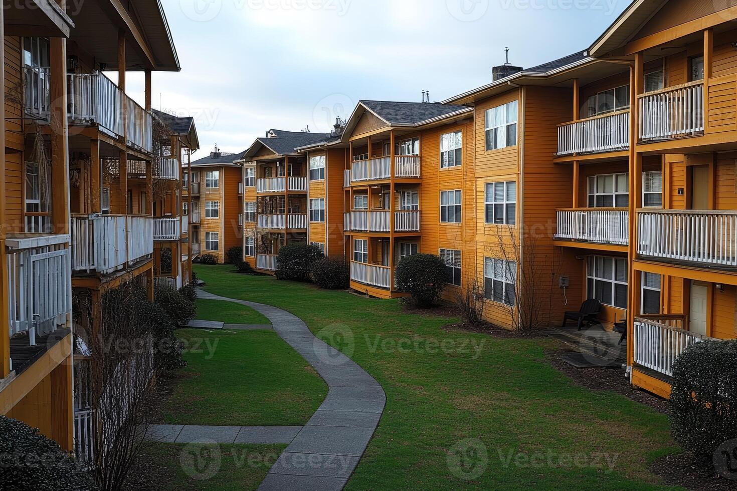 Apartment complex with walkways and grassy areas photo