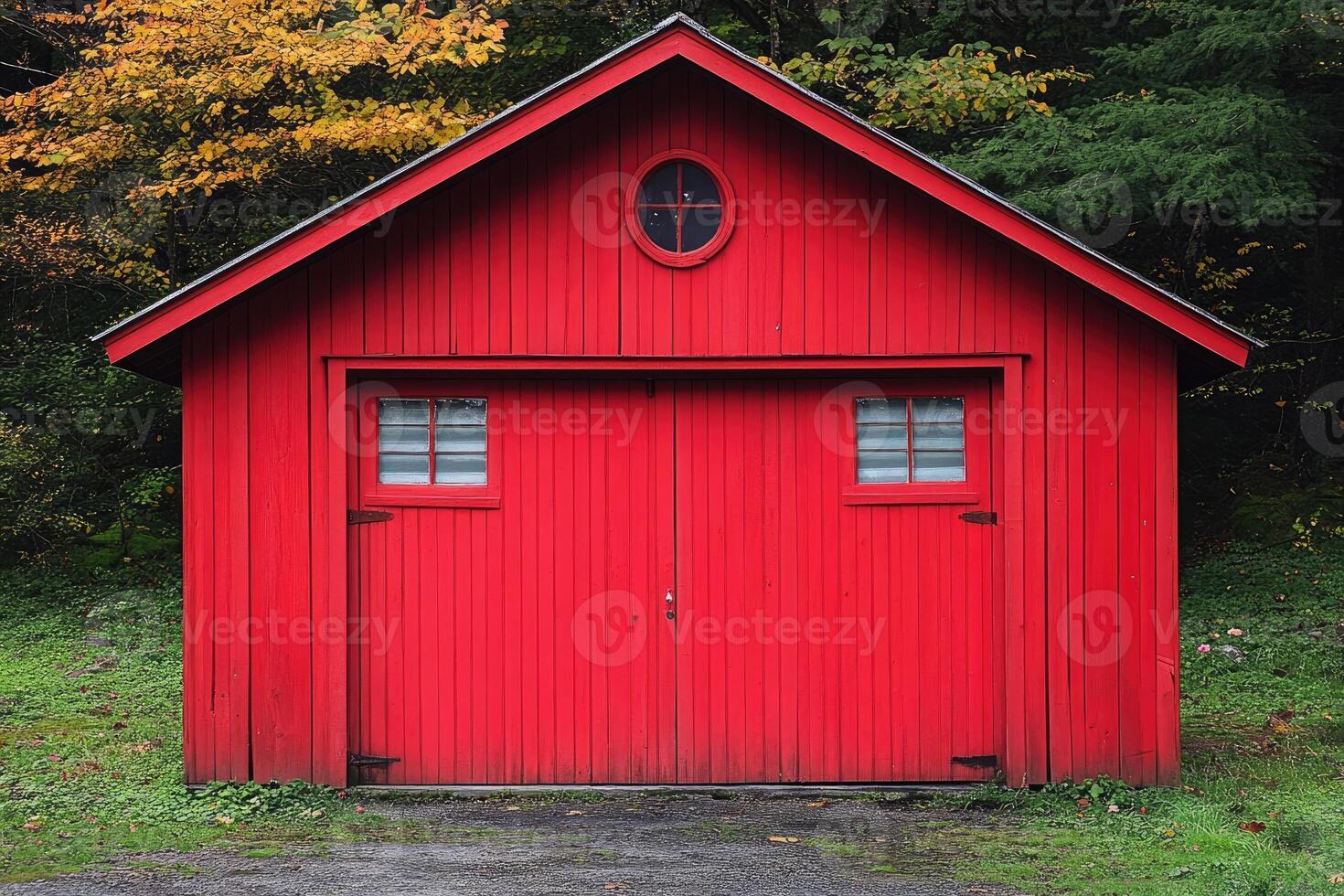 A vibrant red wooden structure stands nestled amongst autumnal foliage photo