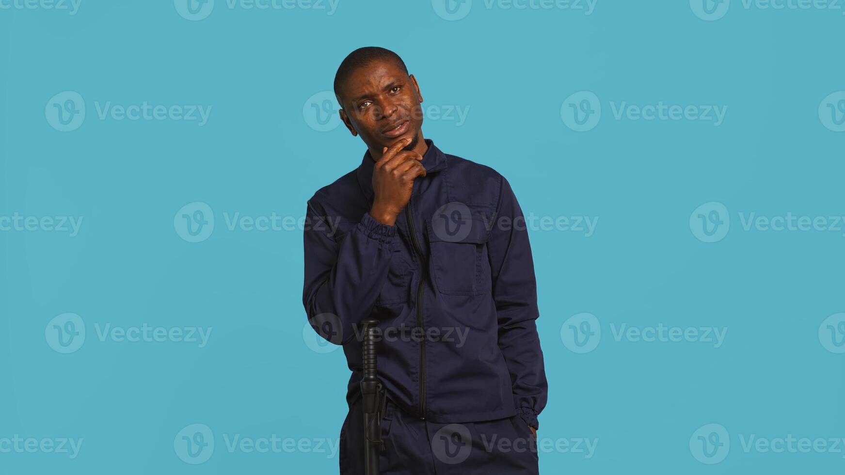 Anxious security guard shaking head, having trouble following orders during protection job shift. Portrait of troubled bodyguard feeling stressed, having problems at work, studio background, camera B photo