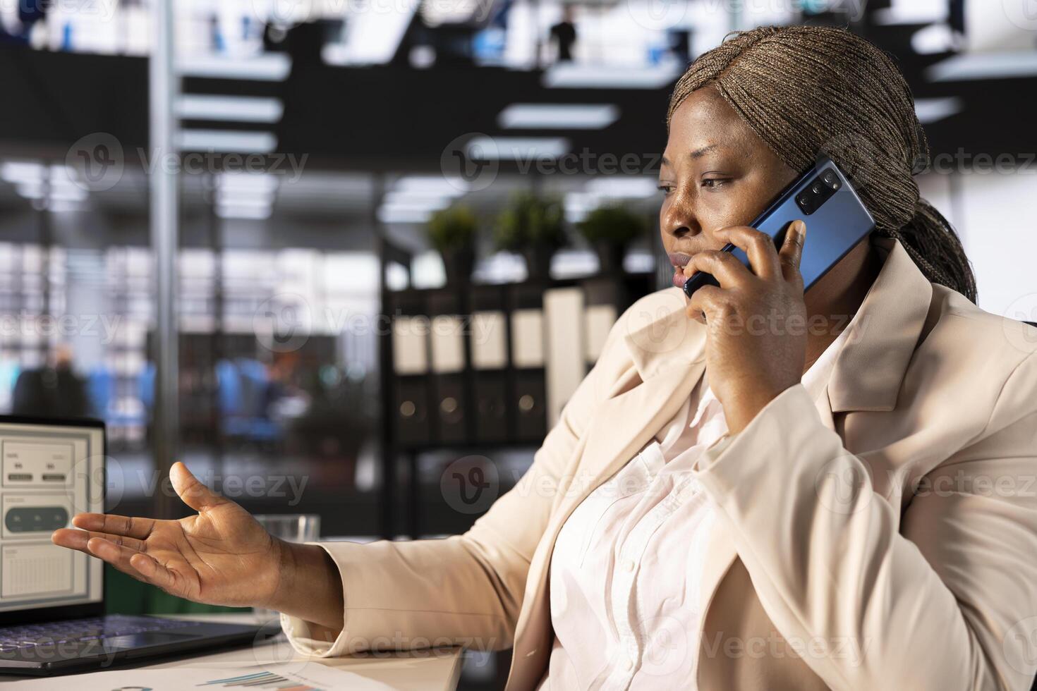 Businesswoman in telephone call with shareholders developing sales strategies to increase market share and profitability. Manager talking on phone with partners to analyze sales performance metrics photo