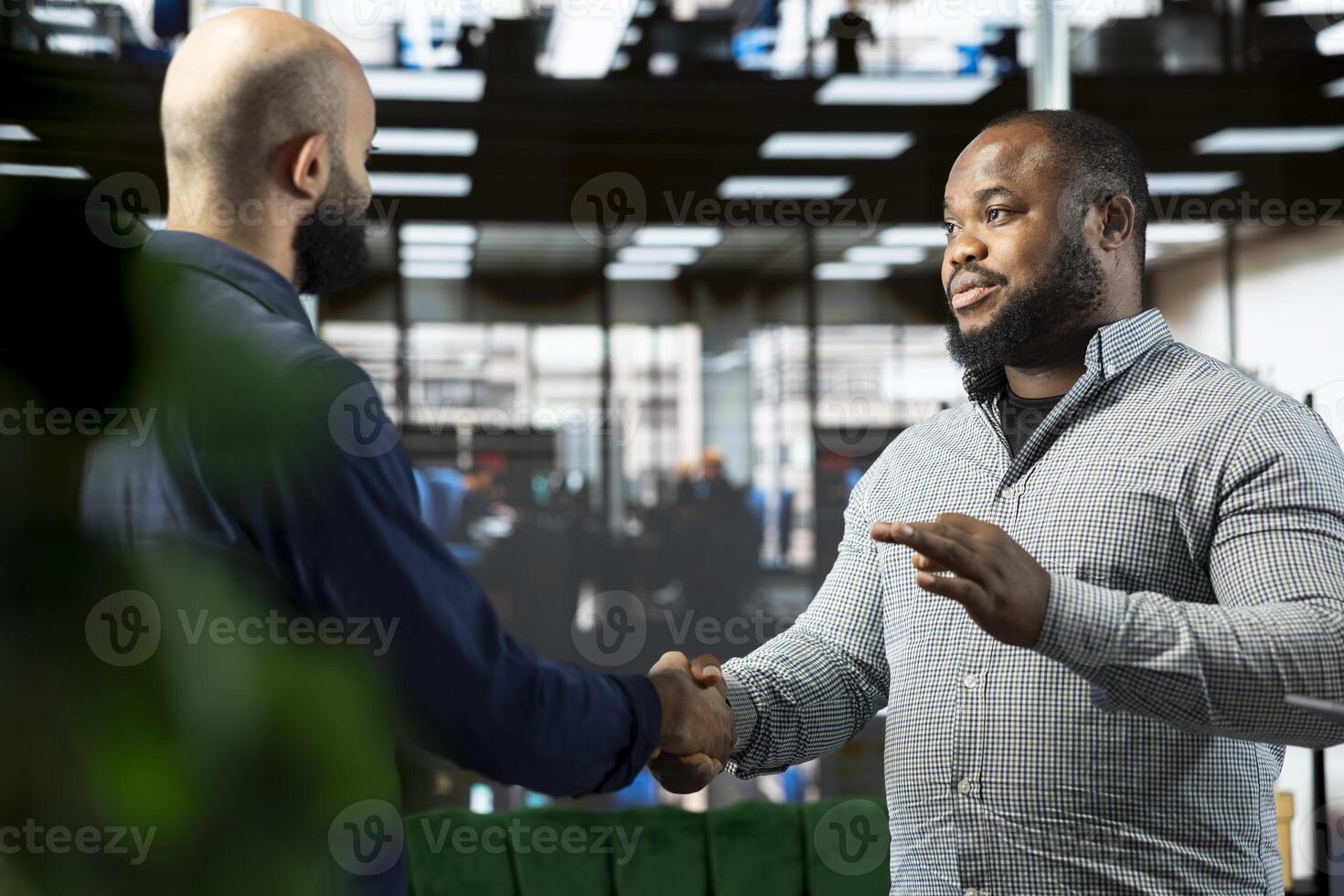 Friendly business managers attending briefing meeting with CEO to share new ideas for profit growth, shaking hands. Man talking to director to explain startup evolution vision, doing handshake photo