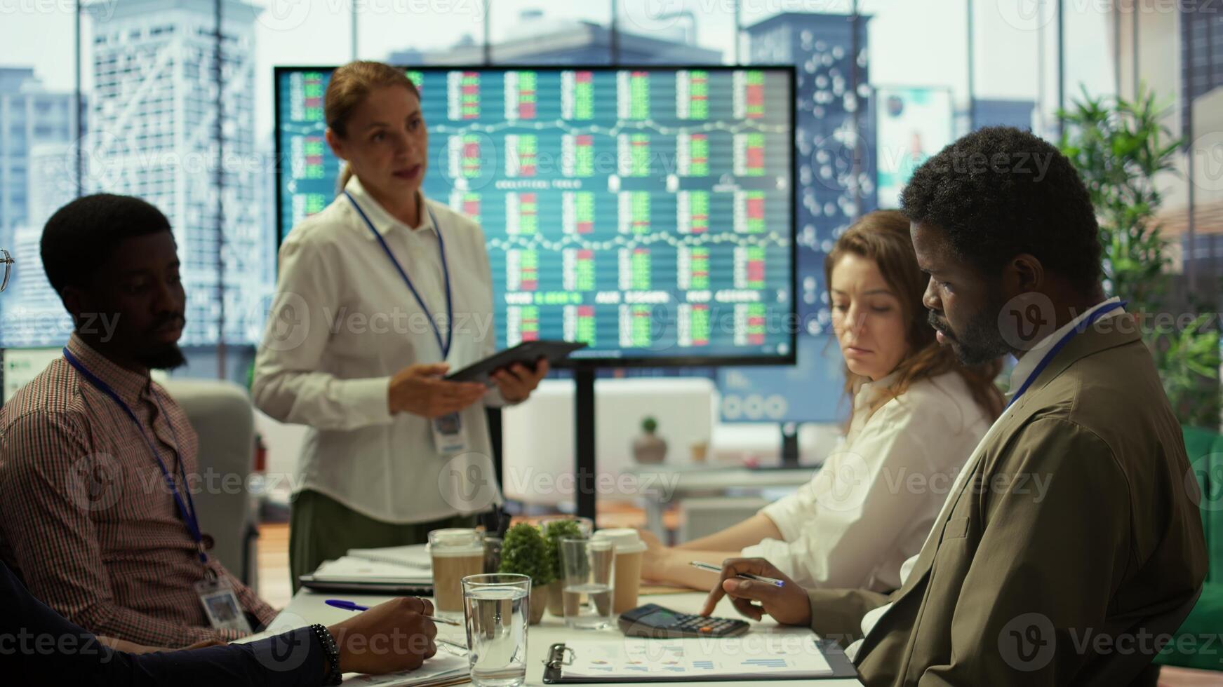 Business coworkers engaging in a collaborative startup meeting, utilizing interactive board and tablet with data visualization to brainstorm solutions and enhance project outcomes. Camera B. photo
