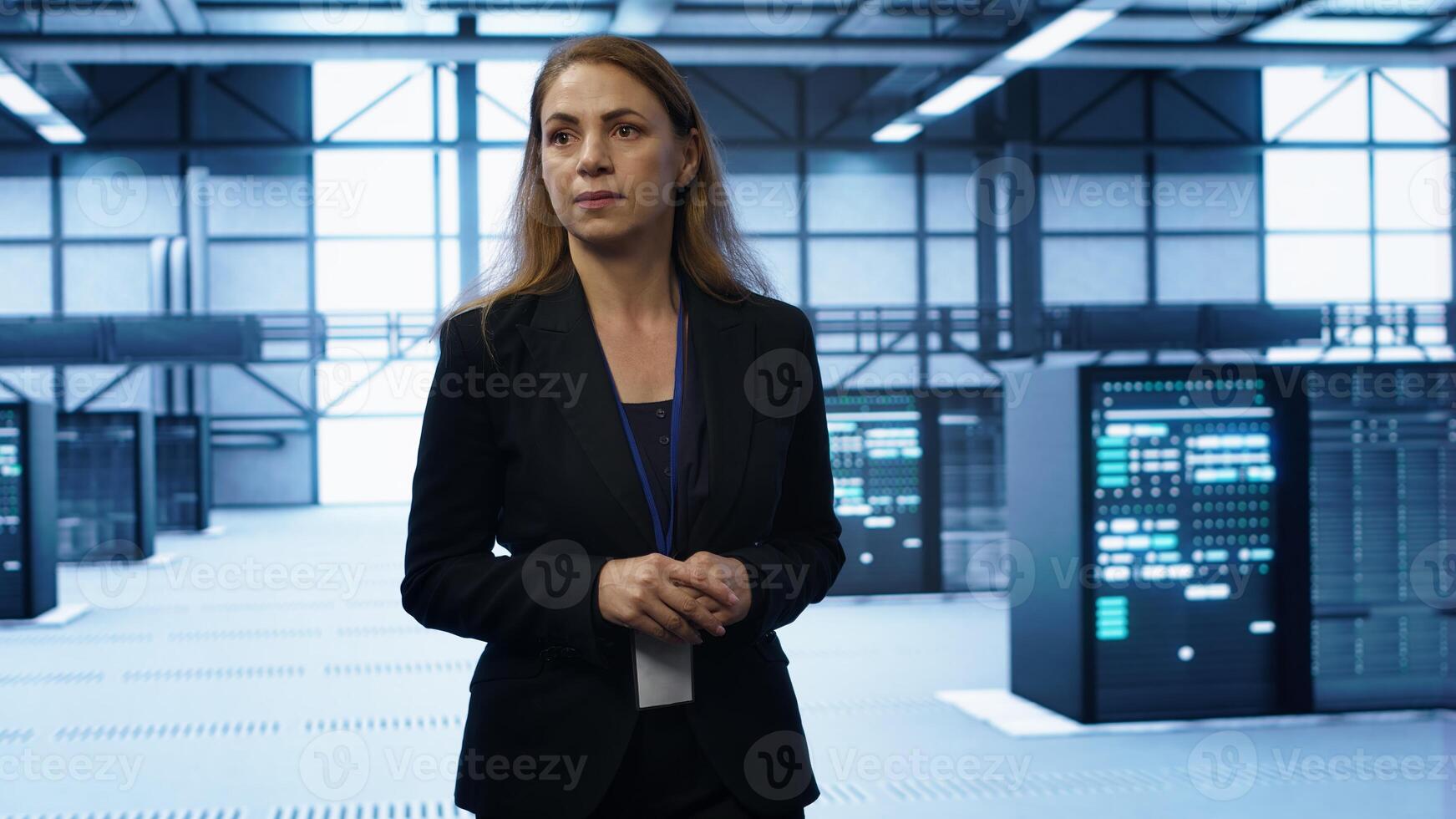 Admin walking in data center, monitoring systems to identify root cause of errors. IT specialist in server farm establishment doing diagnosis, looking for equipment bugs in need of repairing, camera A photo