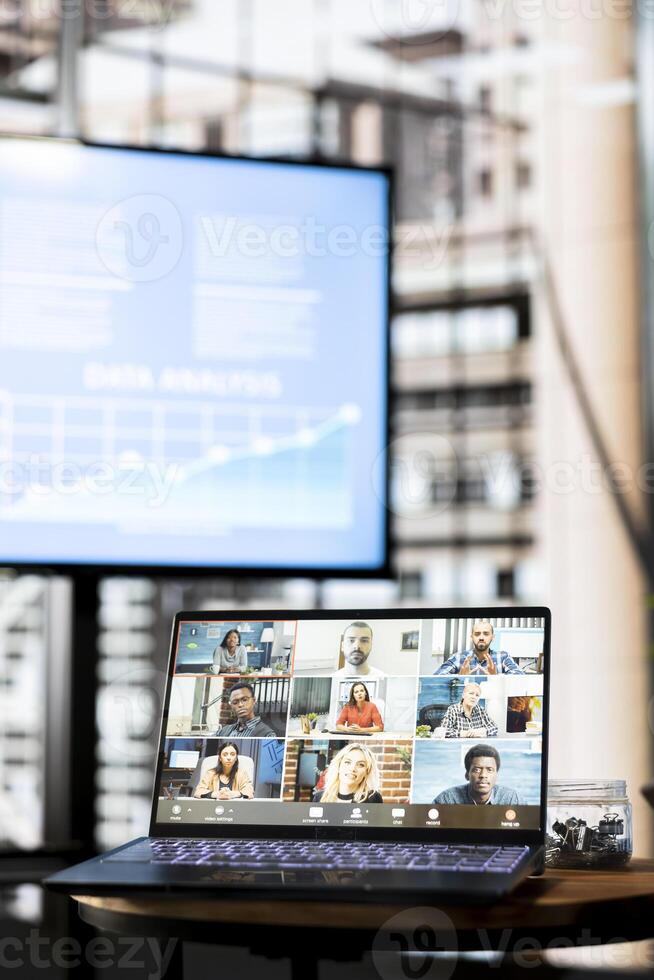 Businessman doing videocall with clients in company office. Entrepreneur talking over internet teleconference meeting with business partners inquiring about commissioned project progress photo