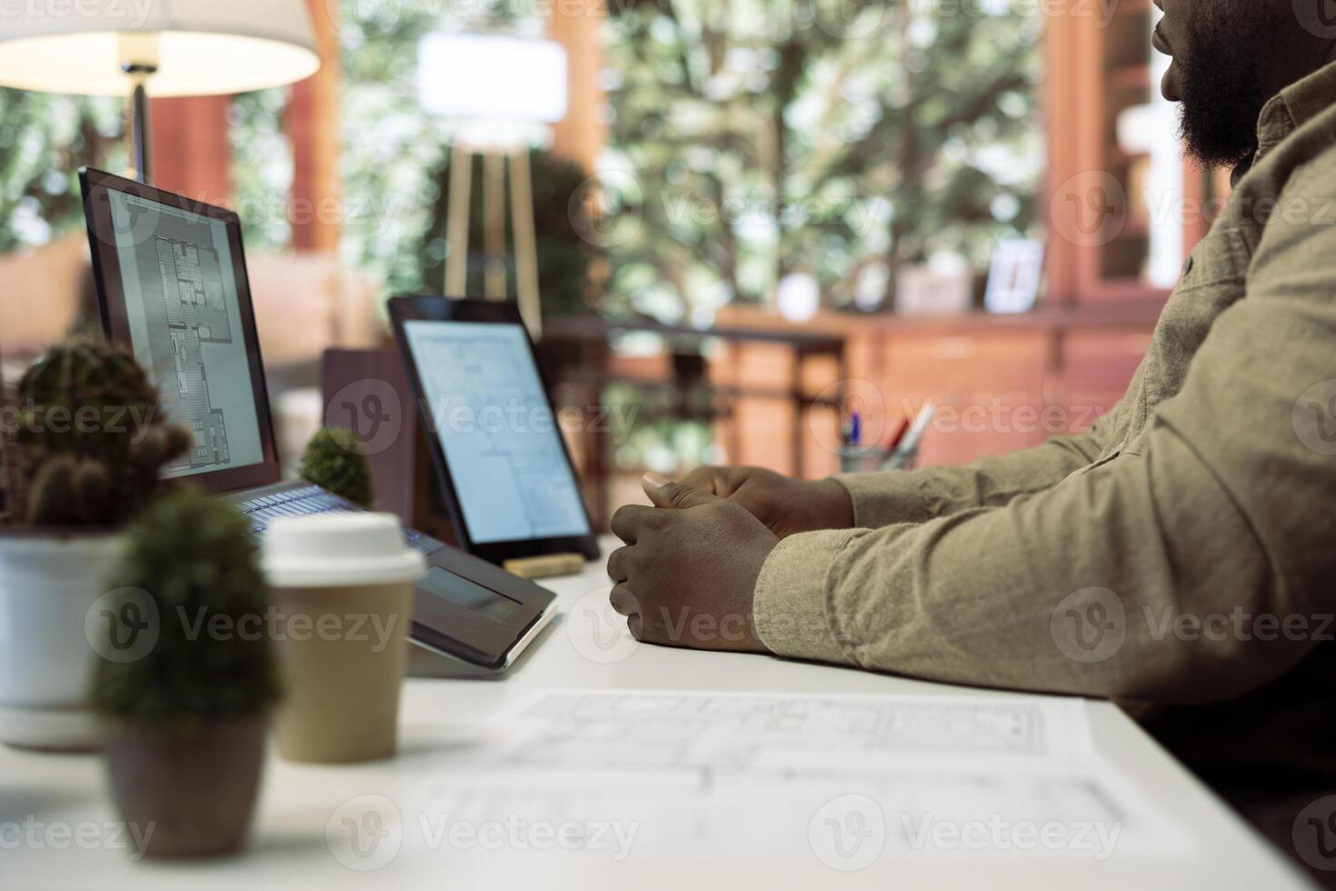 Corporate owner drafting architectural sketches for a new office, looking to relocate the startup headquarters. Collaborating with contractors to design a functional and creative workspace. photo