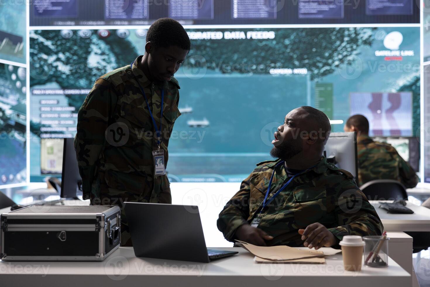 Soldiers team examining real time satellite data and details from old mission files, classified information to support new field operations. Surveillance for security protocols in control room. photo