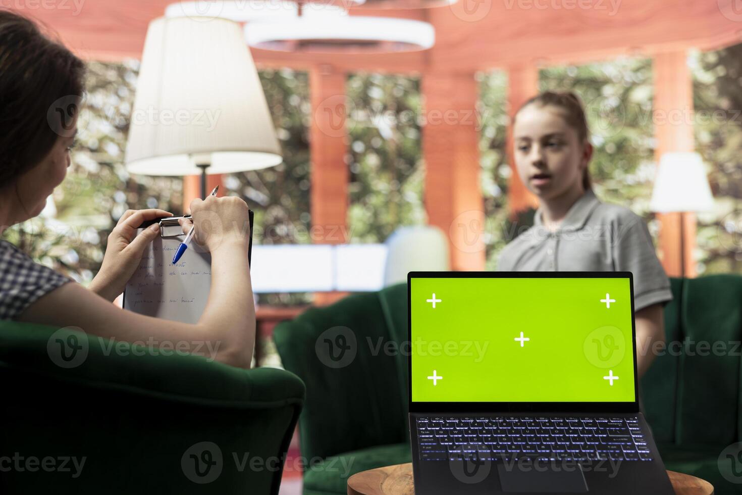 Adolescent in therapy session focused on mental health next to isolated mockup screen, works on emotional well being. Psychotherapist supporting the teen to manage anxiety and depression. photo