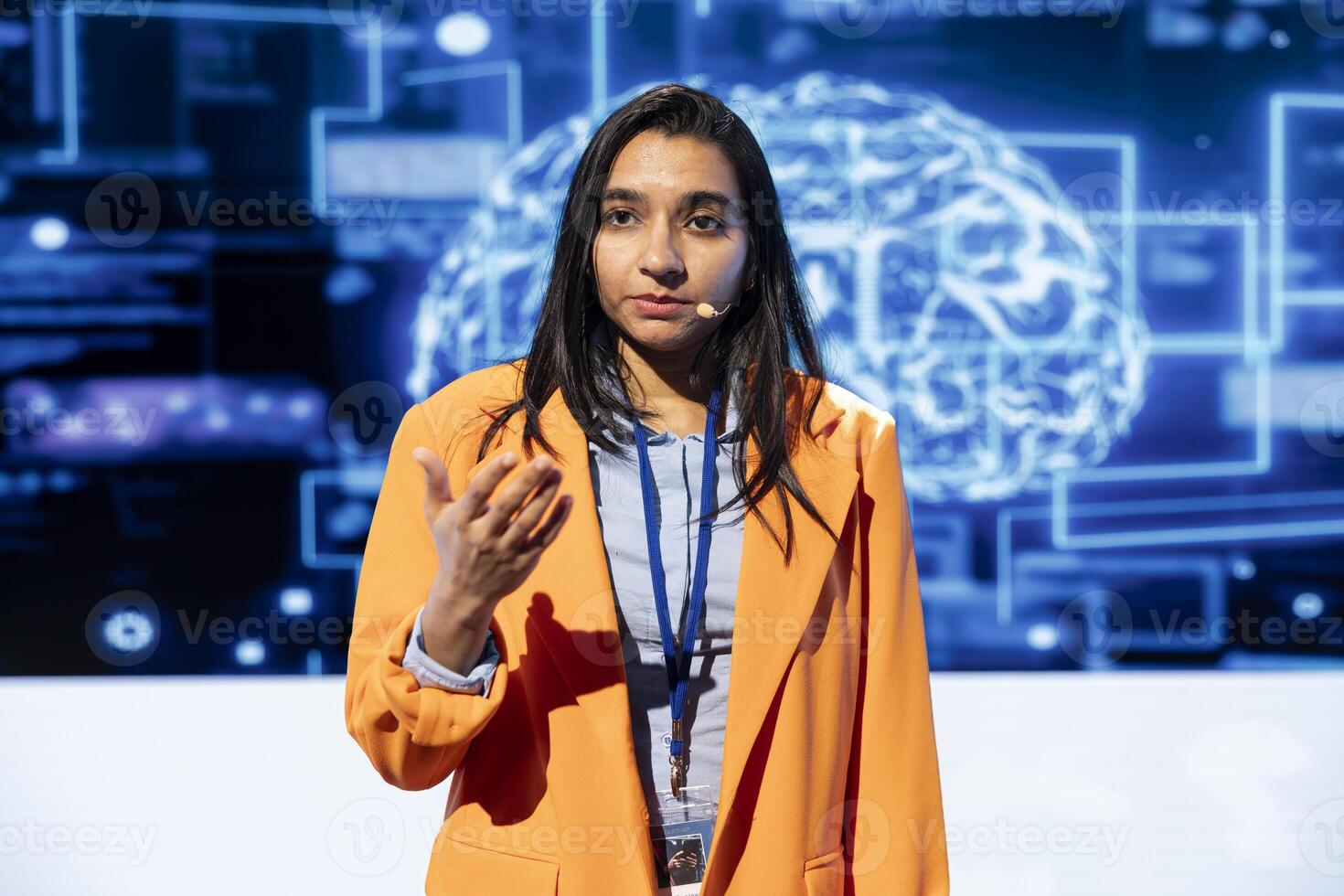Speaker talking with viewers on stage at AI conference bringing together leading experts and researchers to explore latest developments in artificial intelligence and machine learning photo