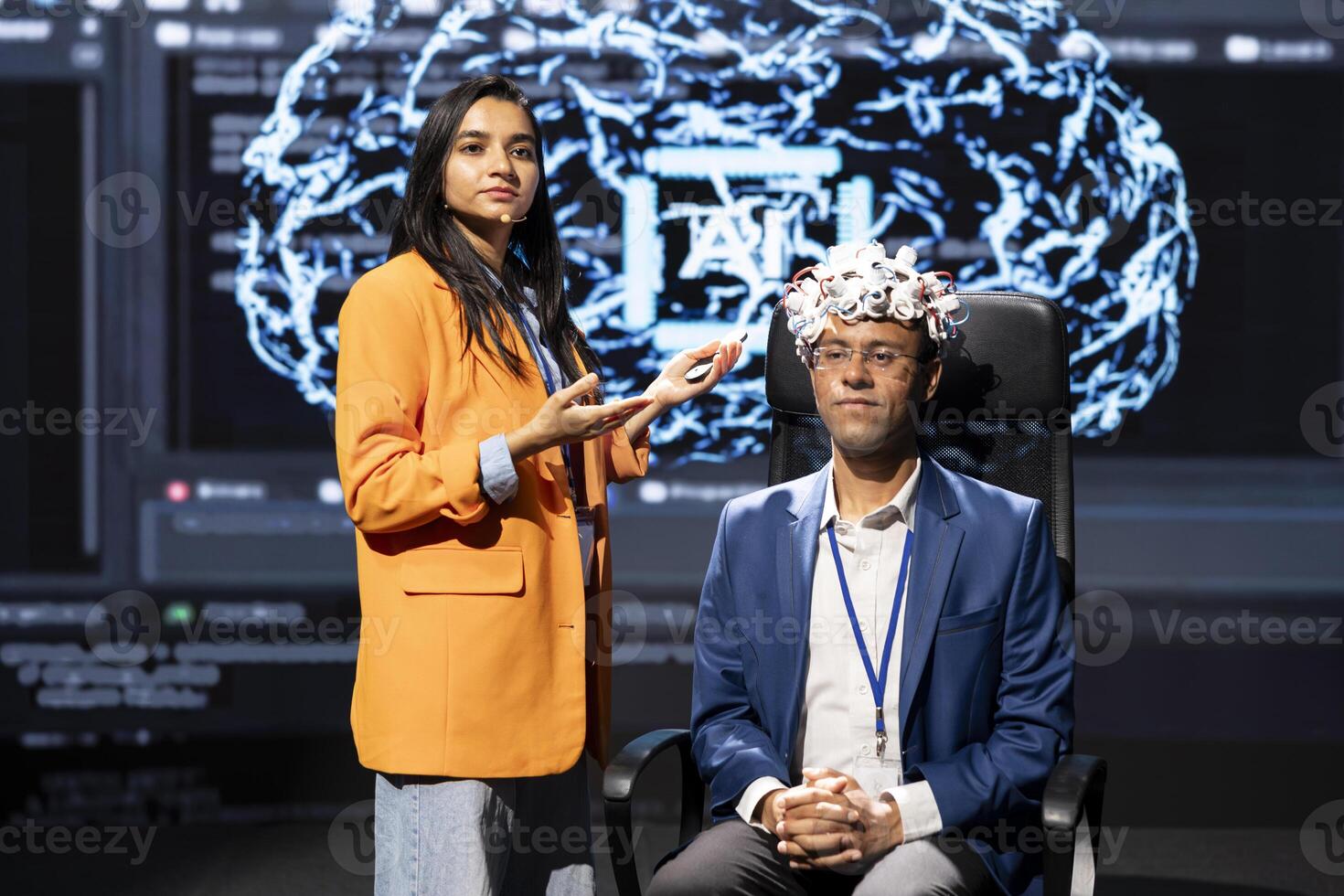 Speaker does EEG headset presentation during tech convention, demonstrating successful implementation of AI in driving forward startup businesses, sharing latest neuroscience discoveries photo